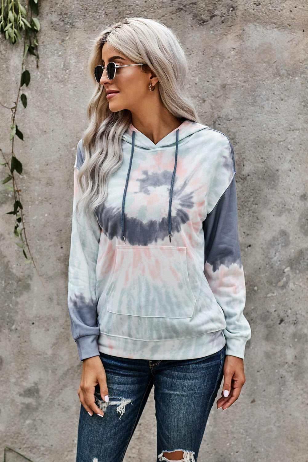 Multicolor tie-dye print pullover hoodie displayed on a mannequin, showcasing vibrant colors and a cozy design.