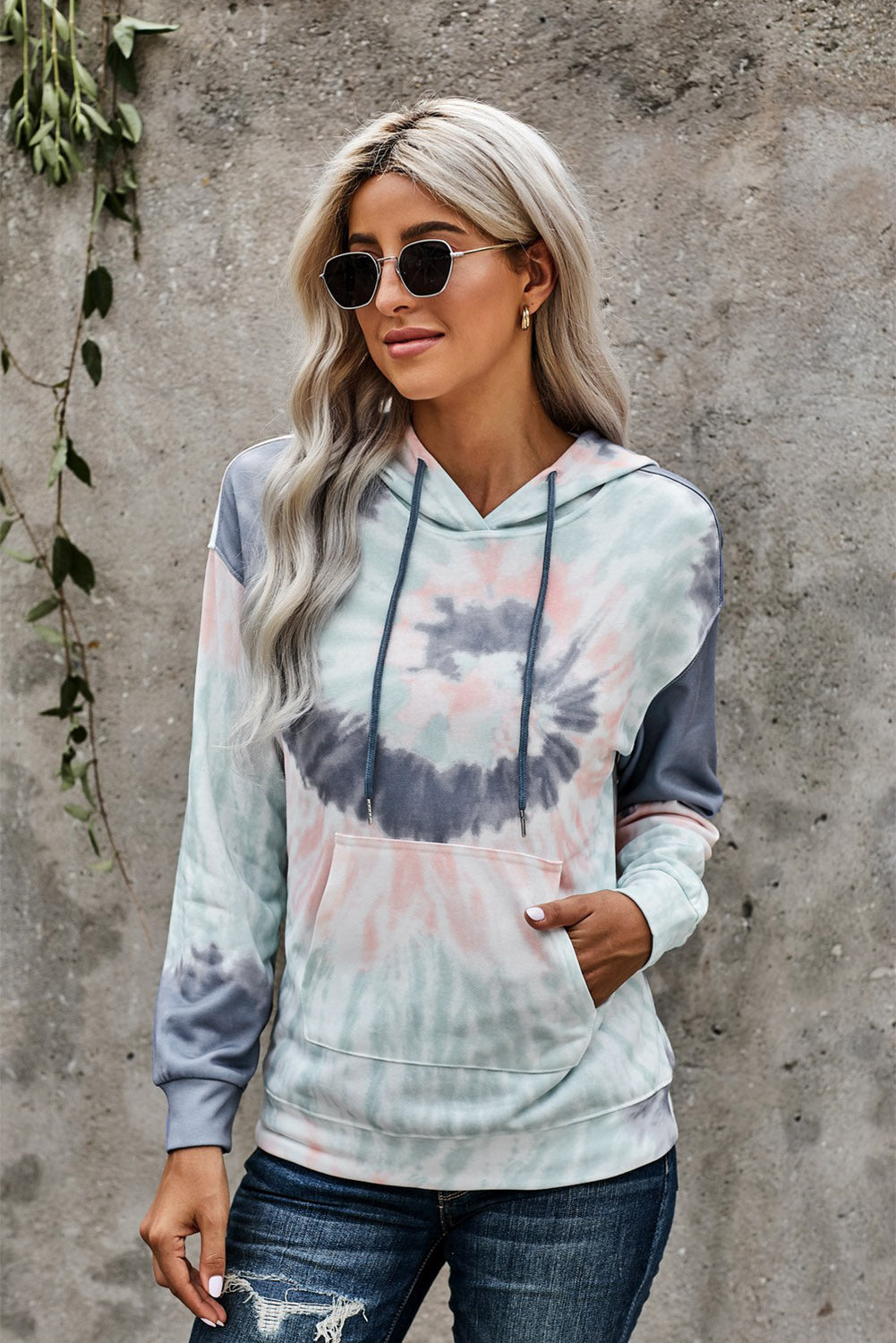 Multicolor tie-dye print pullover hoodie displayed on a mannequin, showcasing vibrant colors and a cozy design.