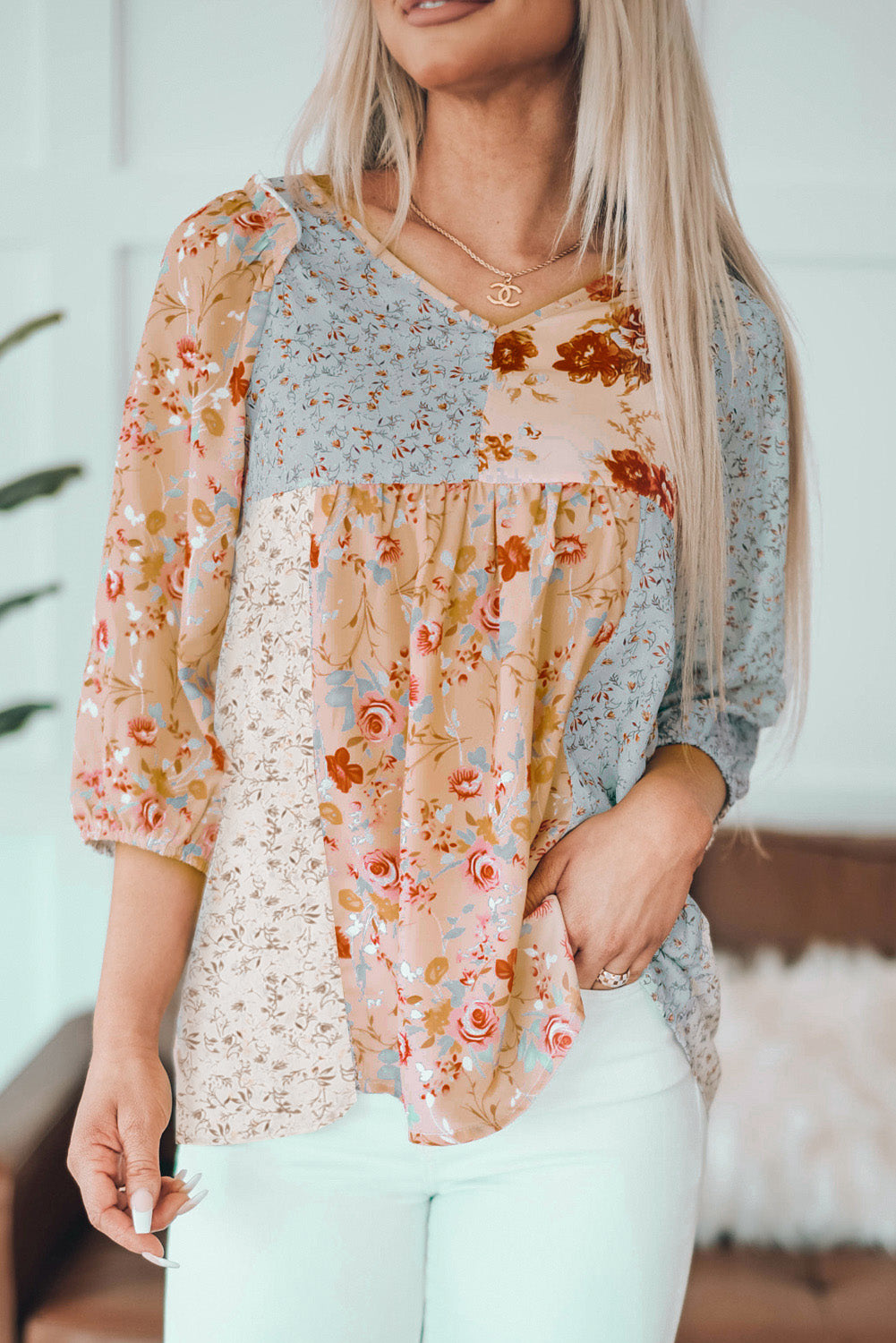 A stylish multicolor V neck babydoll top featuring a mixed floral print, perfect for casual wear.