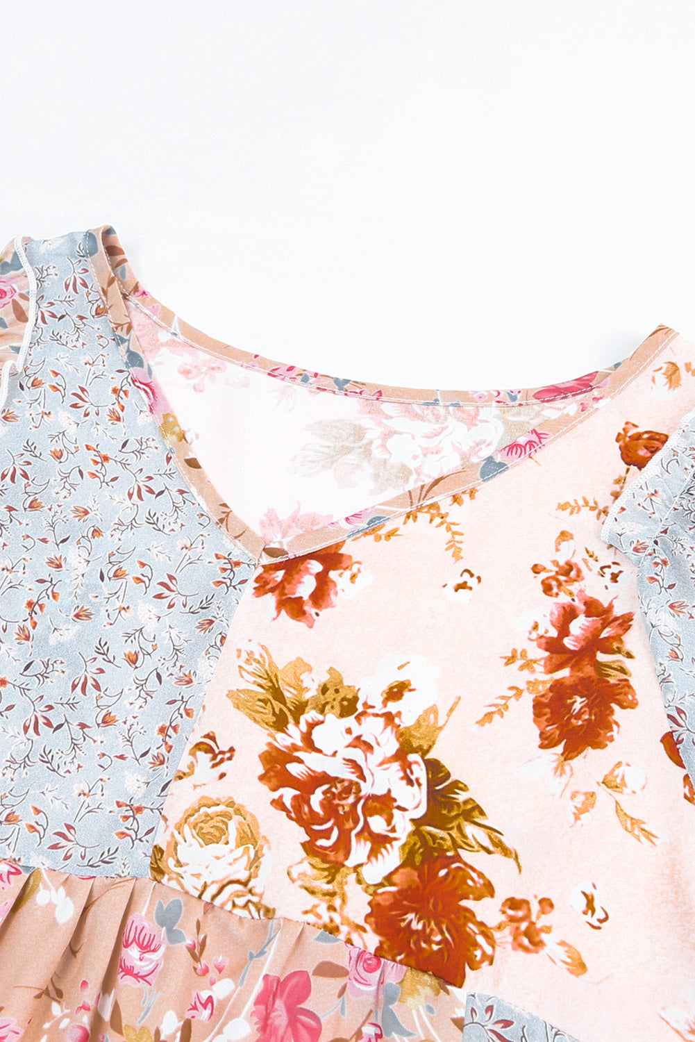 A stylish multicolor V neck babydoll top featuring a mixed floral print, perfect for casual wear.