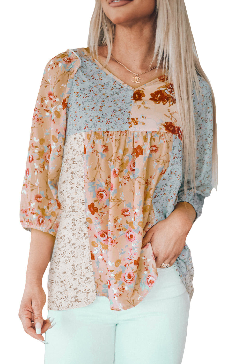 A stylish multicolor V neck babydoll top featuring a mixed floral print, perfect for casual wear.