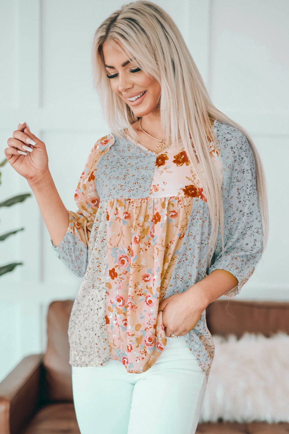 A stylish multicolor V neck babydoll top featuring a mixed floral print, perfect for casual wear.