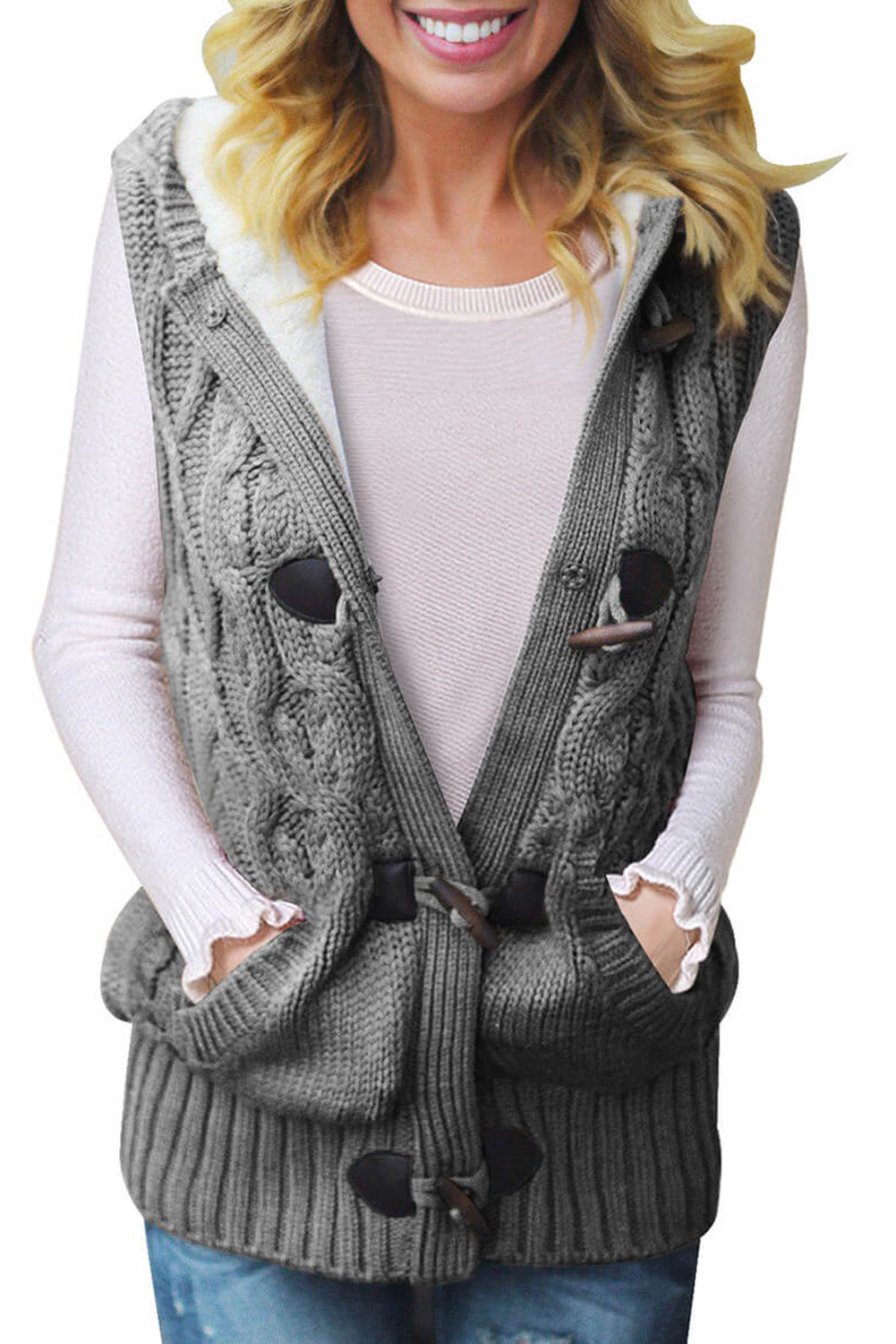 A cozy multicolour cable knit hooded sweater vest with an open front and button-down design, featuring side pockets.