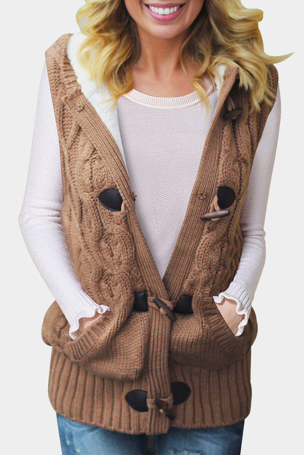 A cozy multicolour cable knit hooded sweater vest with an open front and button-down design, featuring side pockets.