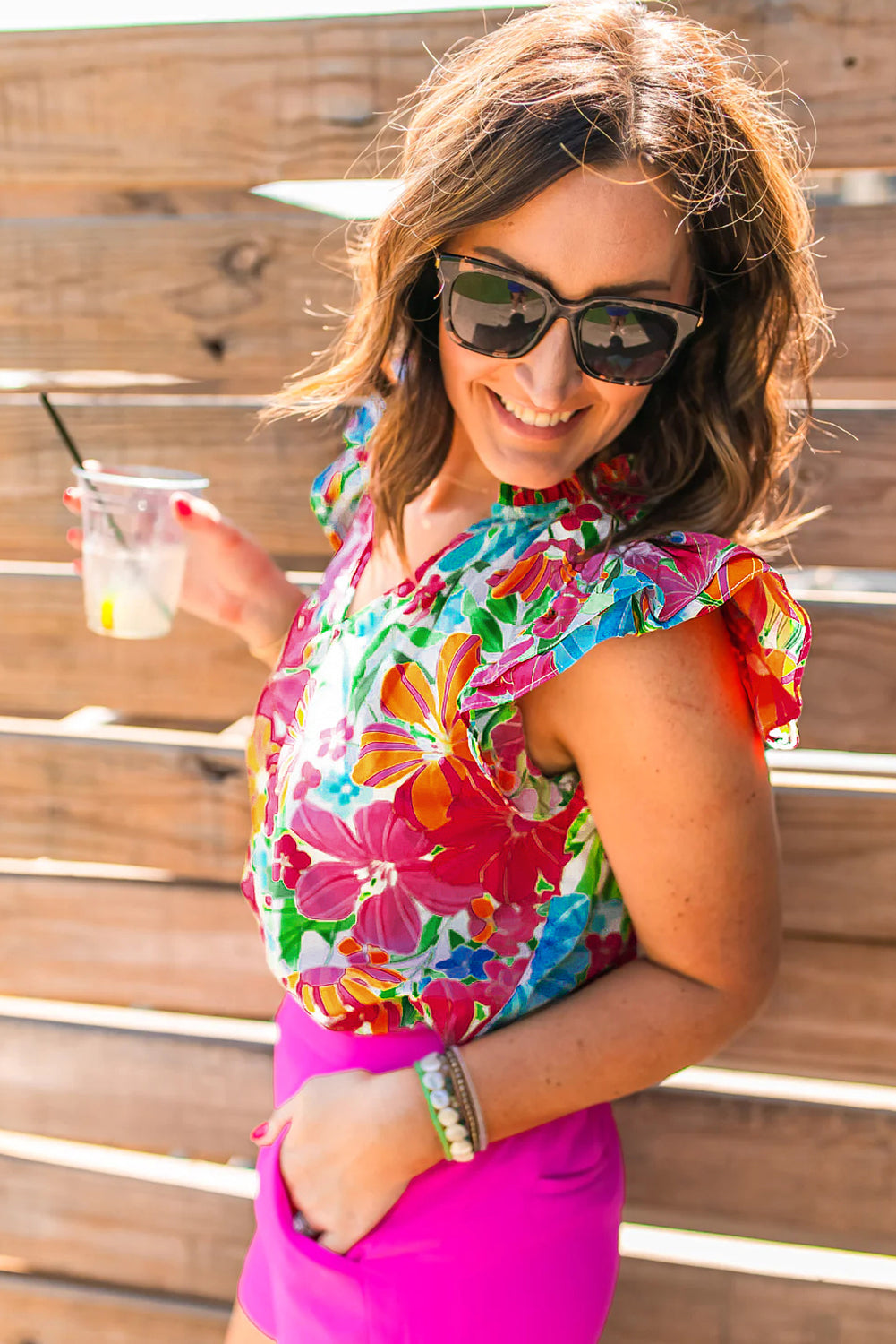 Multicolour floral blouse with flutter sleeves and notched V neck, perfect for casual and formal occasions.