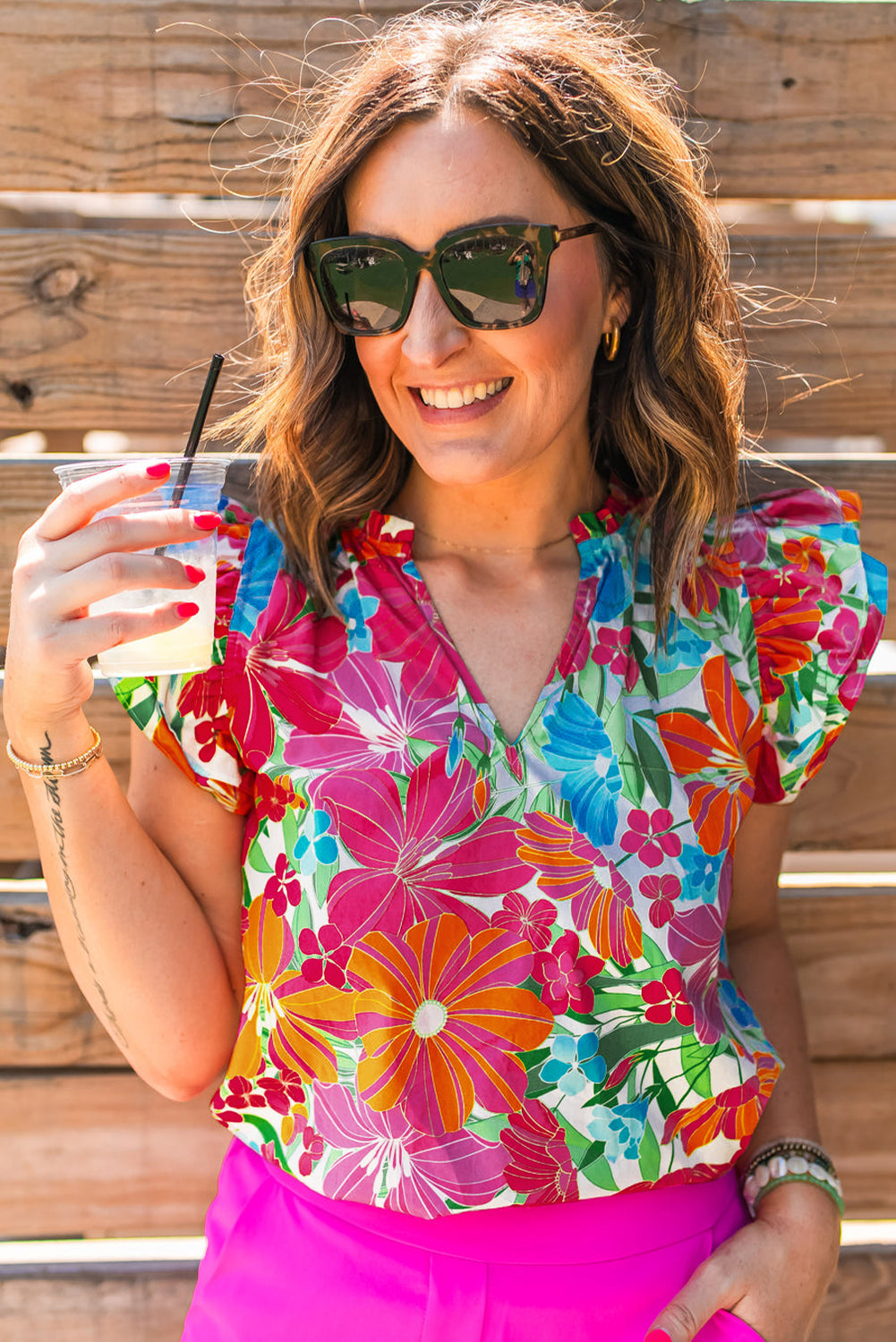 Multicolour floral blouse with flutter sleeves and notched V neck, perfect for casual and formal occasions.