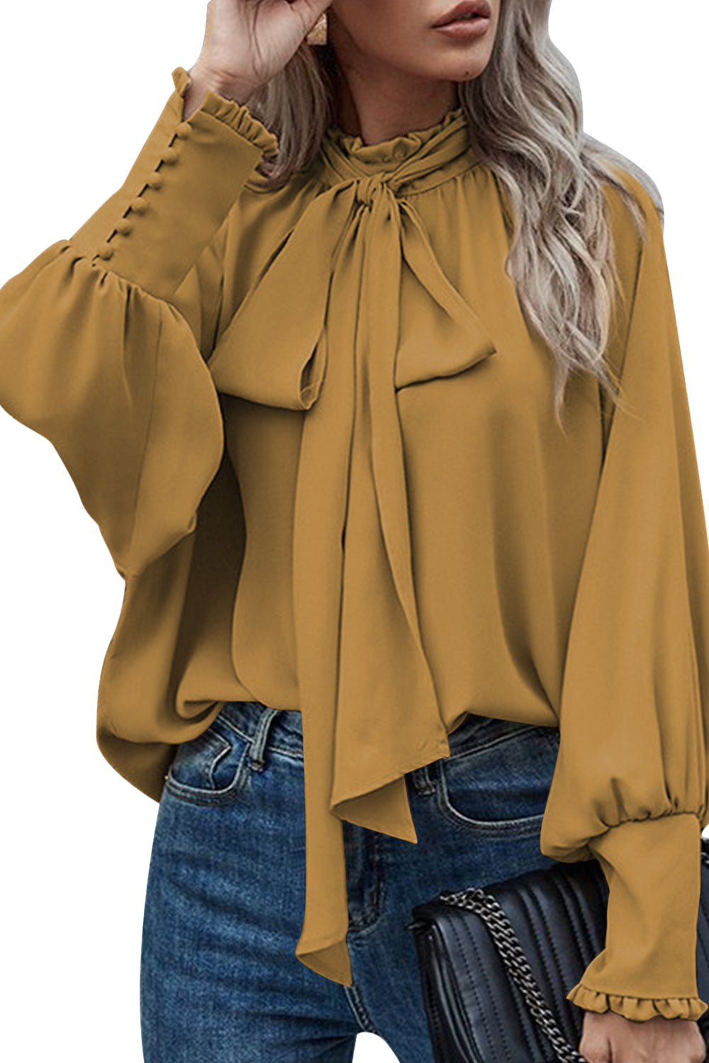 Mustard blouse featuring frilled knotted mock neck and bishop sleeves, showcasing a chic and elegant design.