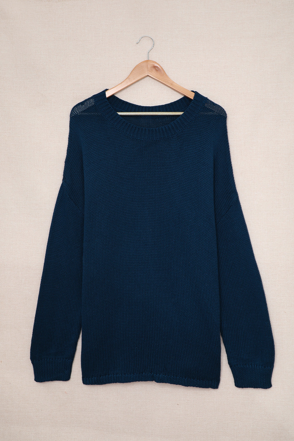 A cozy navy long sleeves turtleneck sweater displayed on a mannequin, showcasing its soft fabric and elegant design.