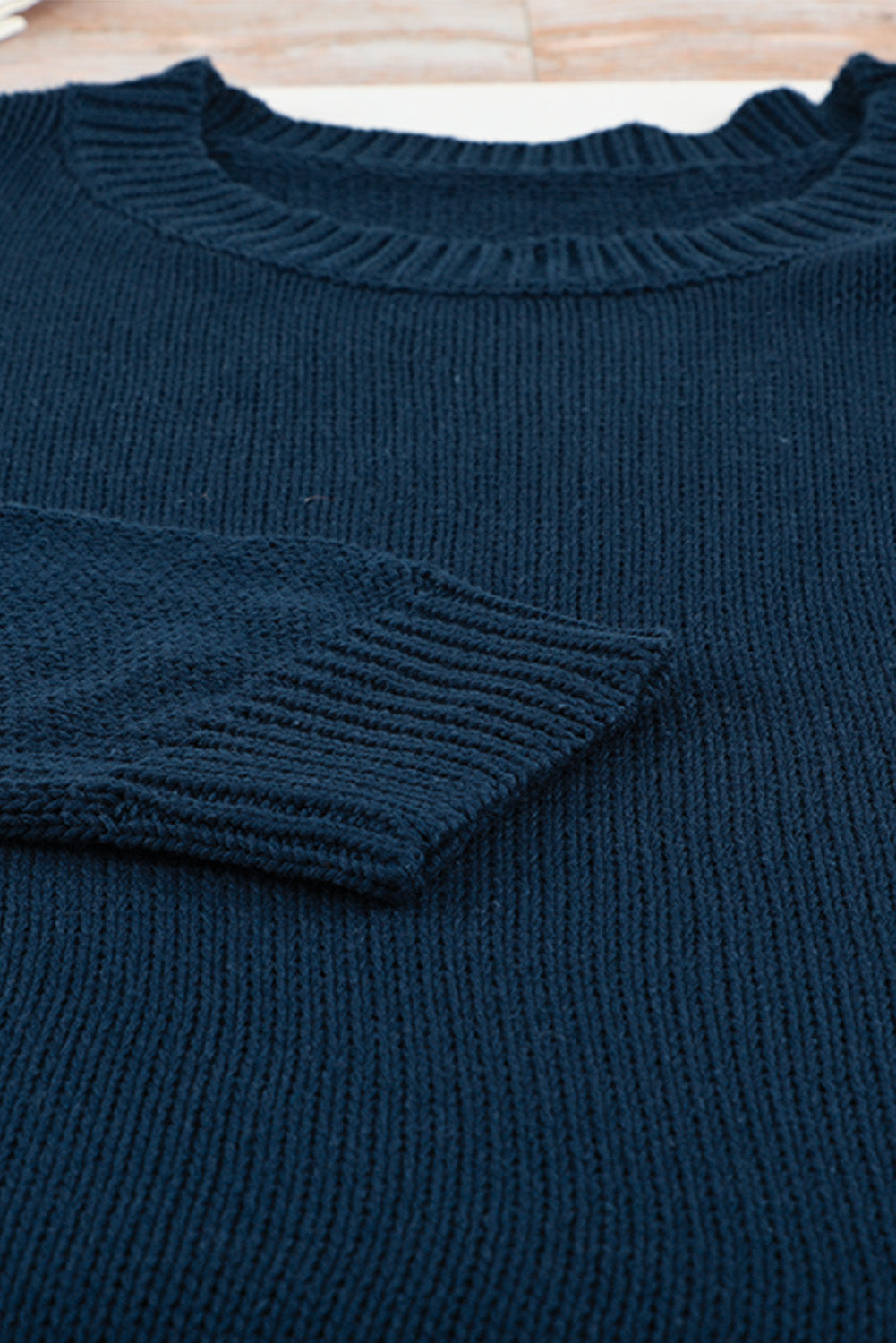 A cozy navy long sleeves turtleneck sweater displayed on a mannequin, showcasing its soft fabric and elegant design.