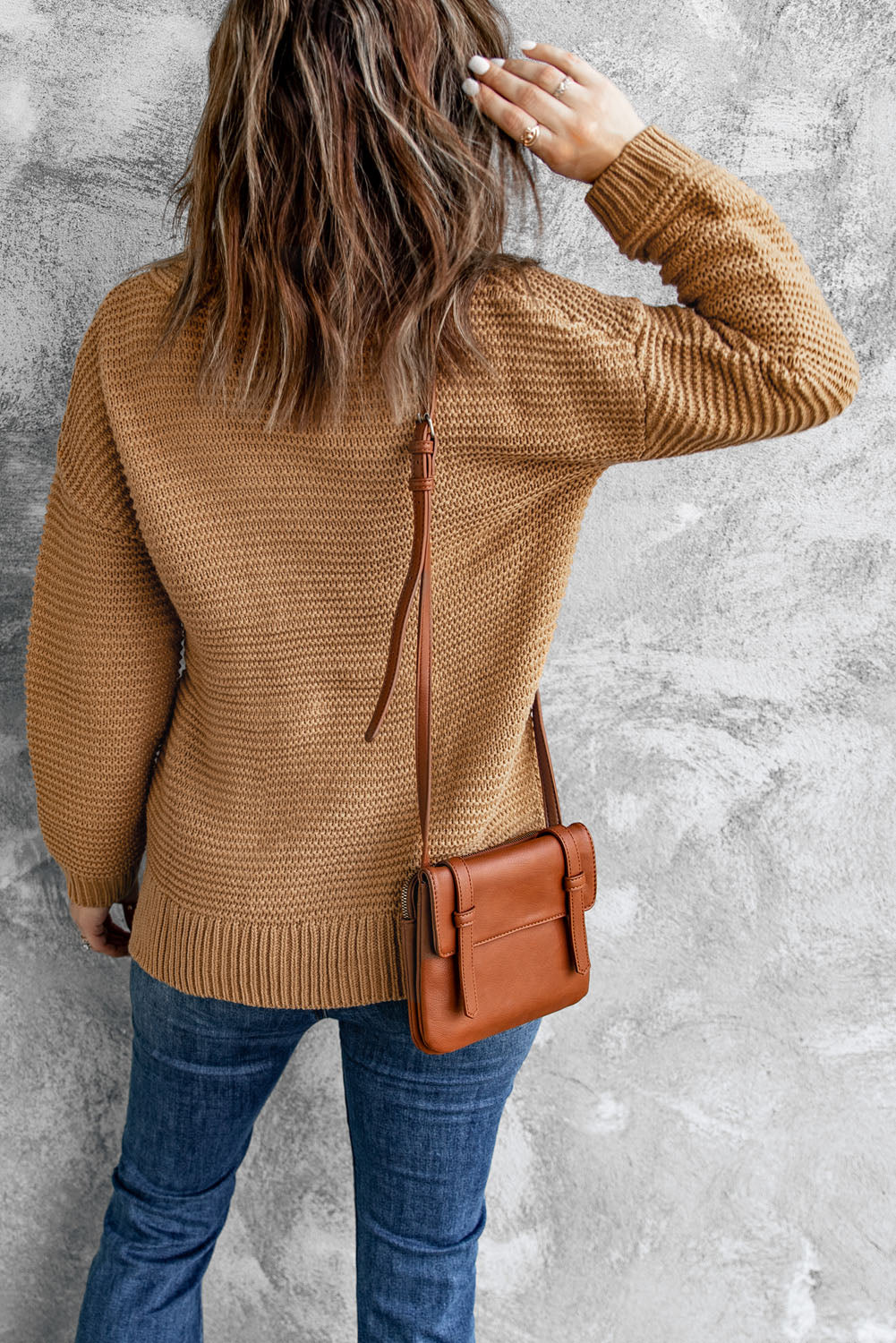 A cozy navy long sleeves turtleneck sweater displayed on a mannequin, showcasing its soft fabric and elegant design.