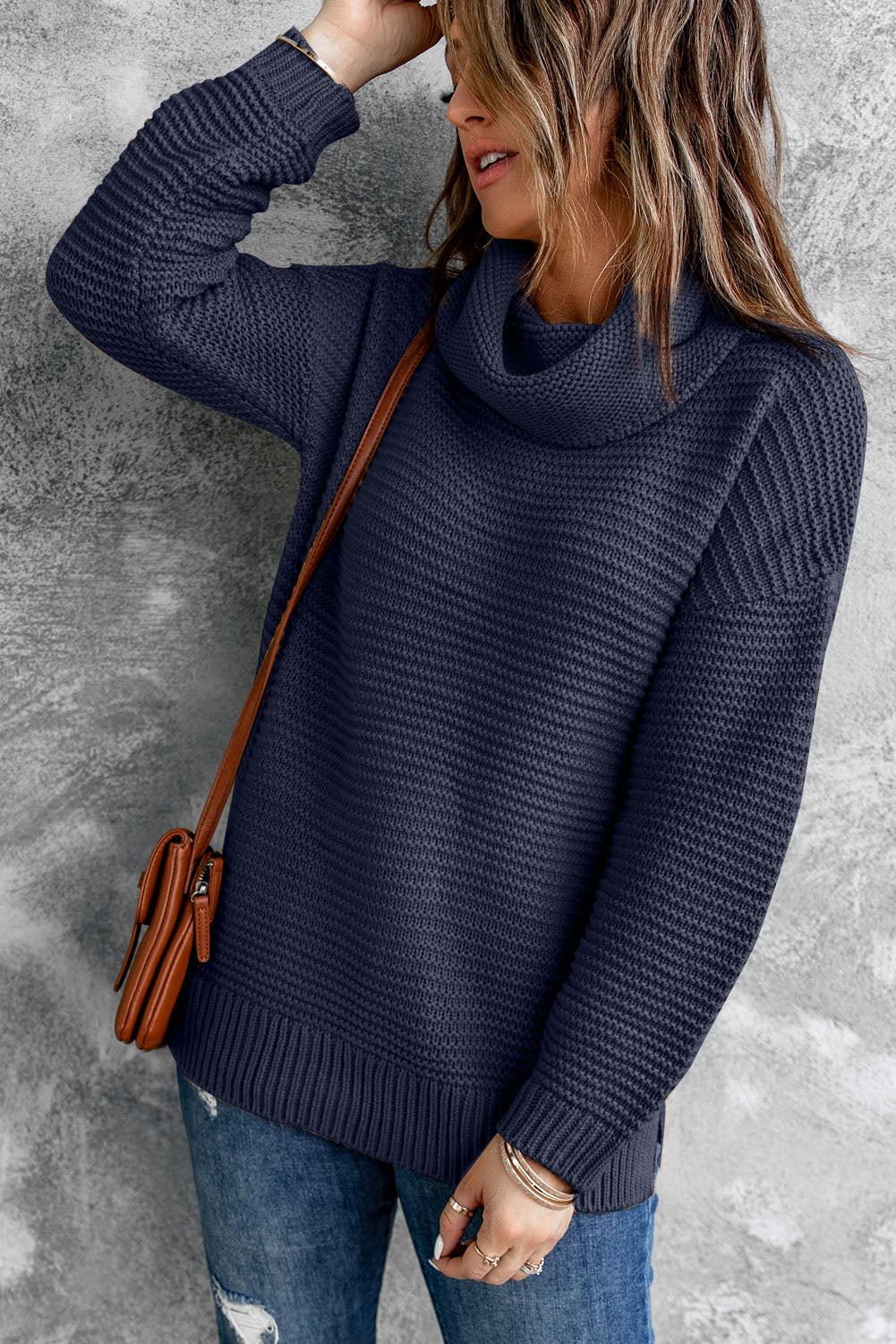 A cozy navy long sleeves turtleneck sweater displayed on a mannequin, showcasing its soft fabric and elegant design.