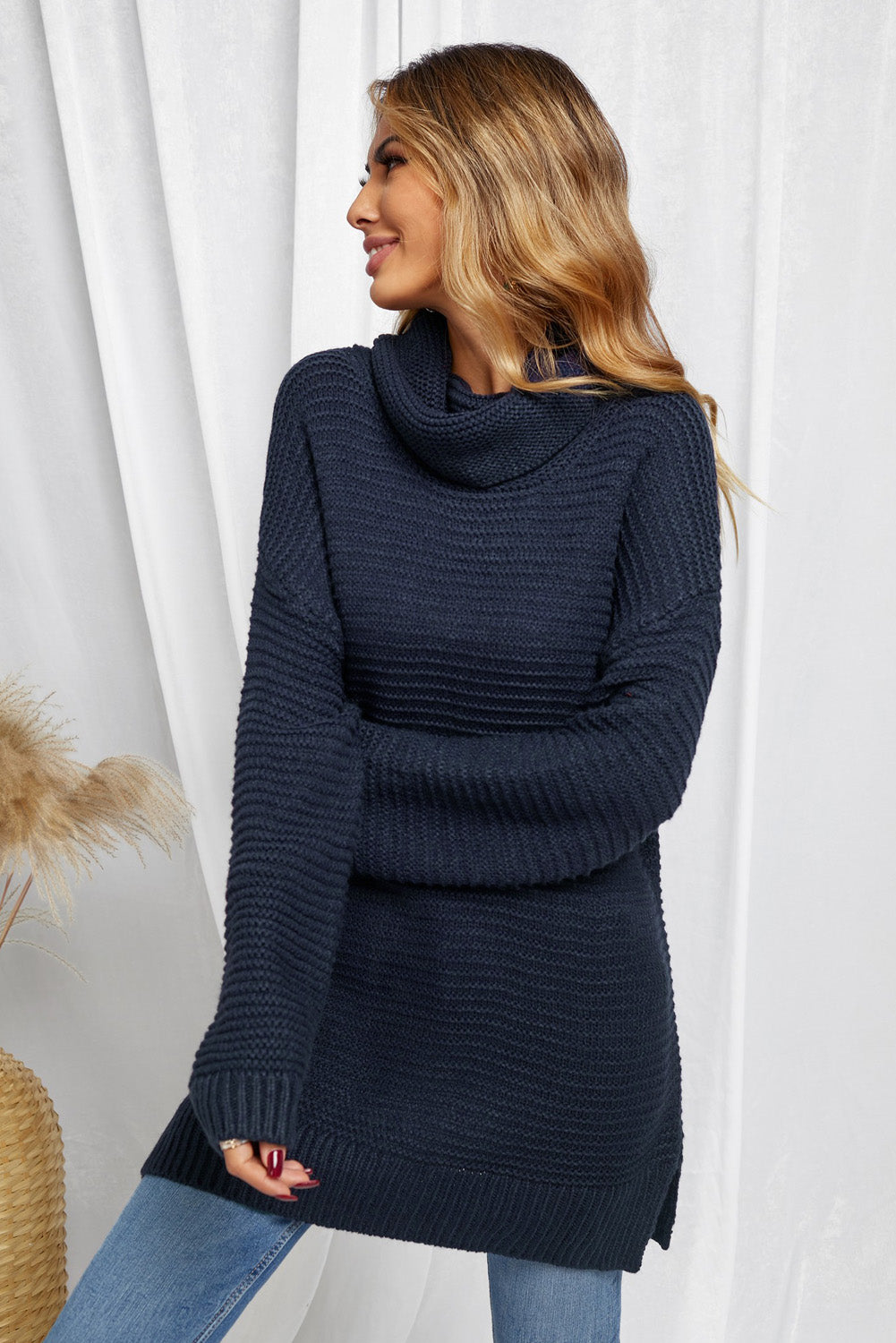 A cozy navy long sleeves turtleneck sweater displayed on a mannequin, showcasing its soft fabric and elegant design.