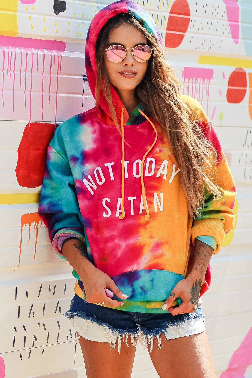 A colorful tie-dye hoodie featuring the phrase 'Not Today Satan' in white text, showcasing a unique blend of vibrant colors.