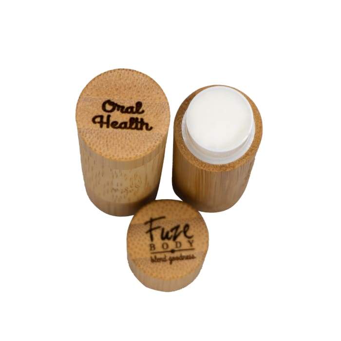 Organic Oral Health Lip Balm in bamboo dispenser, featuring natural ingredients like coconut oil and essential oils for lip care.