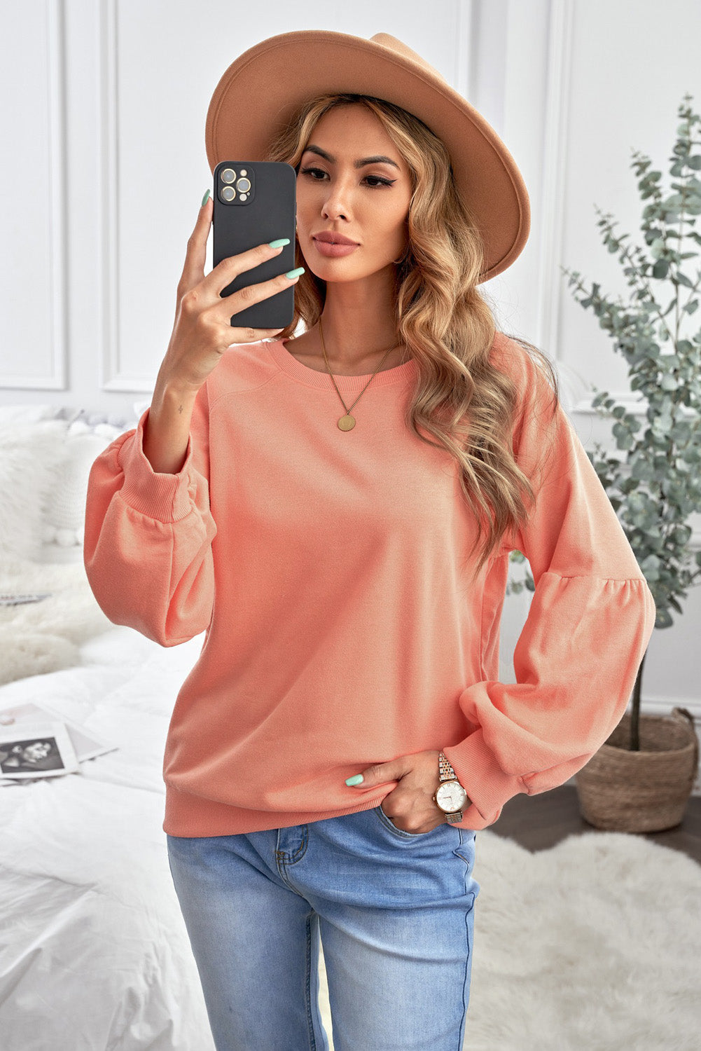 Orange pullover sweatshirt with patchwork raglan sleeves, showcasing a trendy and stylish design suitable for casual wear.