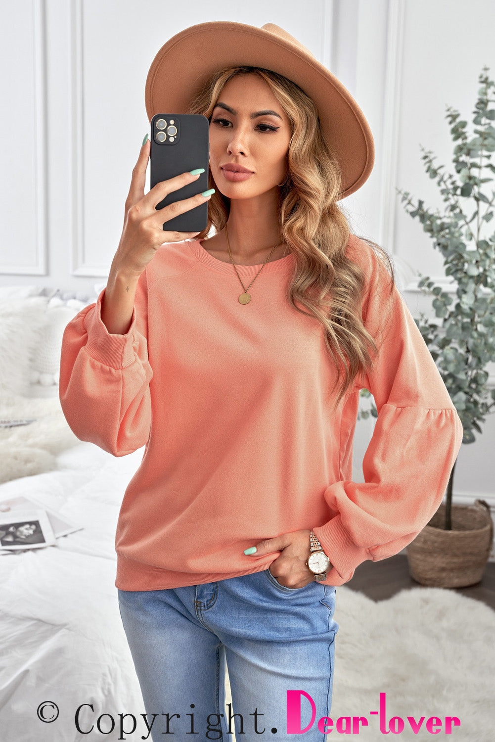 Orange pullover sweatshirt with patchwork raglan sleeves, showcasing a trendy and stylish design suitable for casual wear.