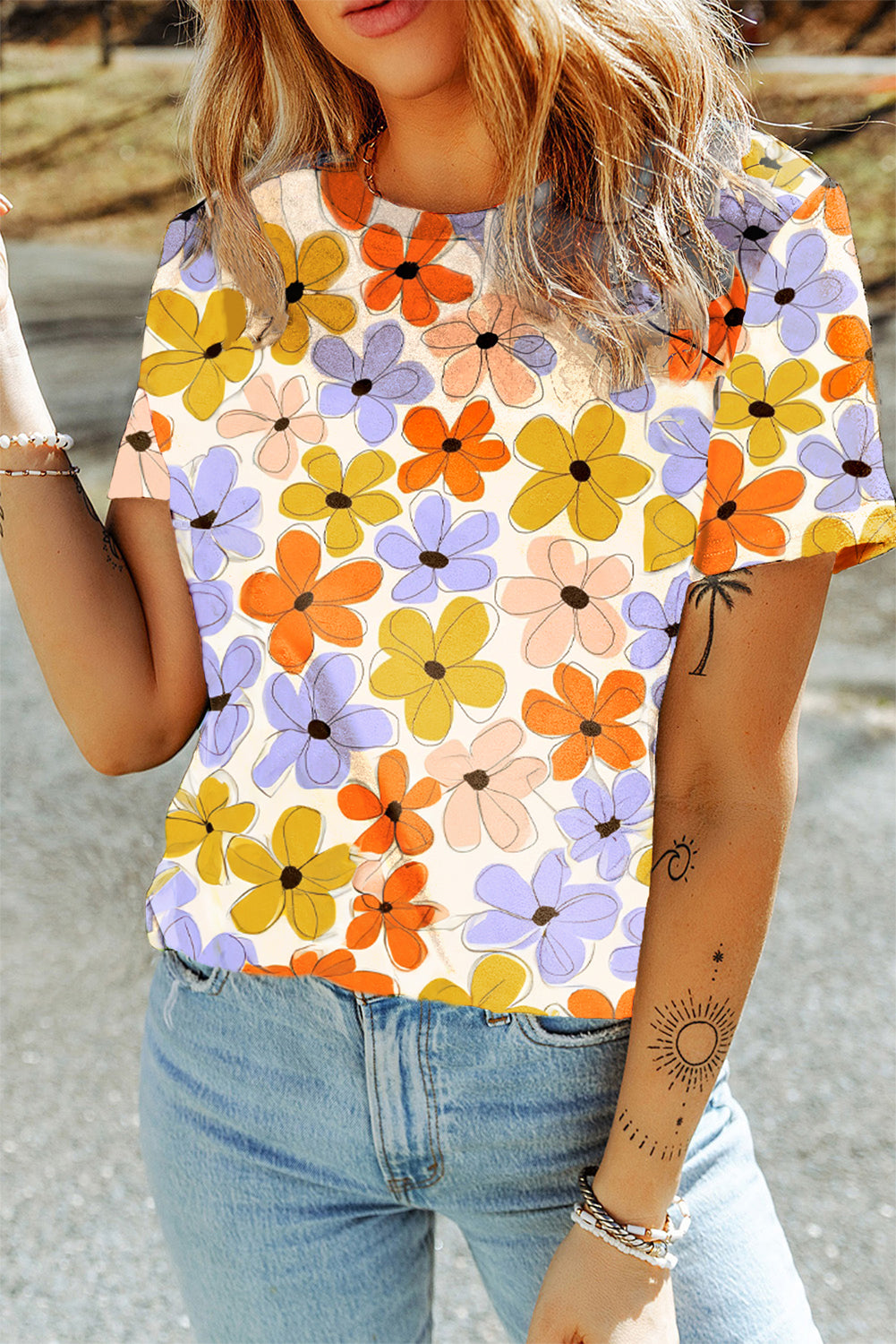 A vibrant orange t-shirt featuring a summer flower print, showcasing a casual round neck design, perfect for warm weather wear.