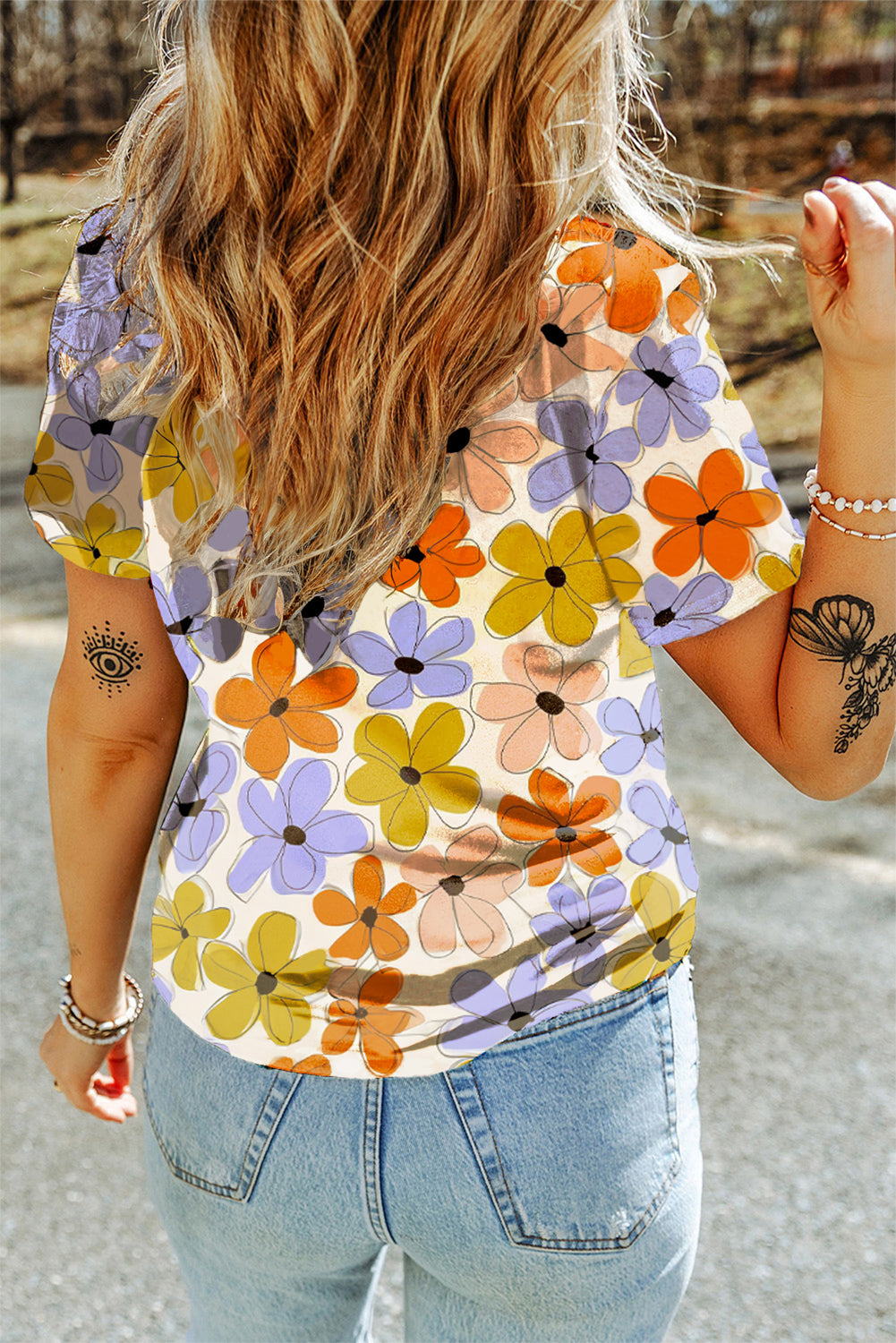 A vibrant orange t-shirt featuring a summer flower print, showcasing a casual round neck design, perfect for warm weather wear.