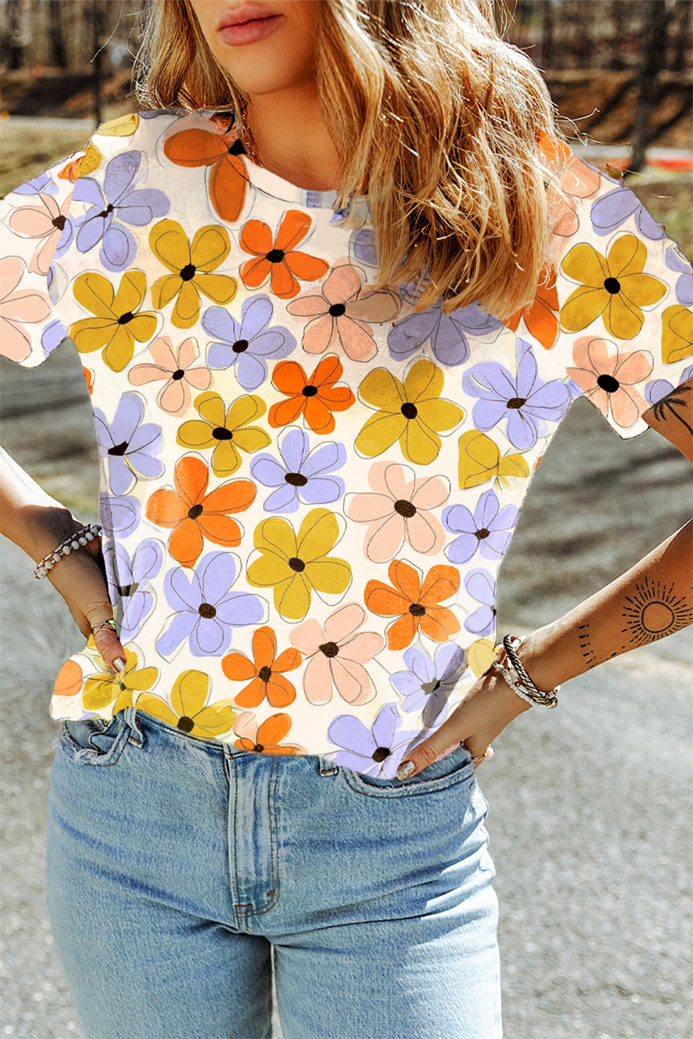 A vibrant orange t-shirt featuring a summer flower print, showcasing a casual round neck design, perfect for warm weather wear.