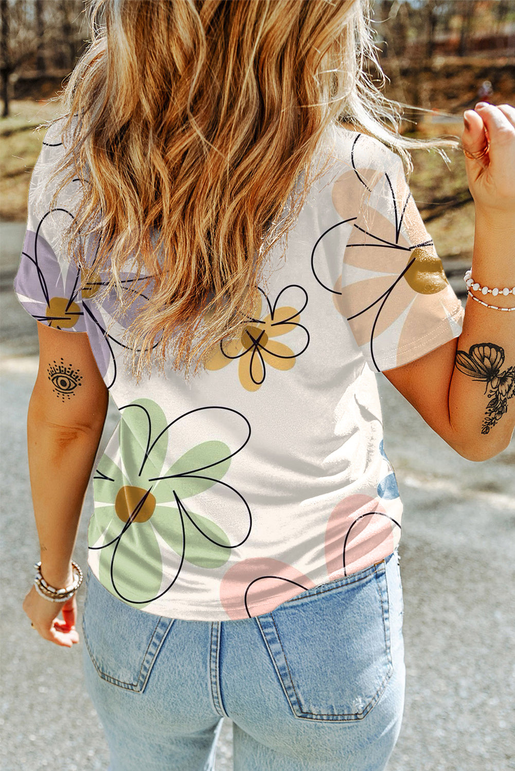 A vibrant orange t-shirt featuring a summer flower print, showcasing a casual round neck design, perfect for warm weather wear.