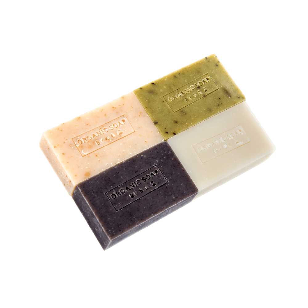 A collection of organic bar soaps in various scents, showcasing their natural ingredients and eco-friendly packaging.