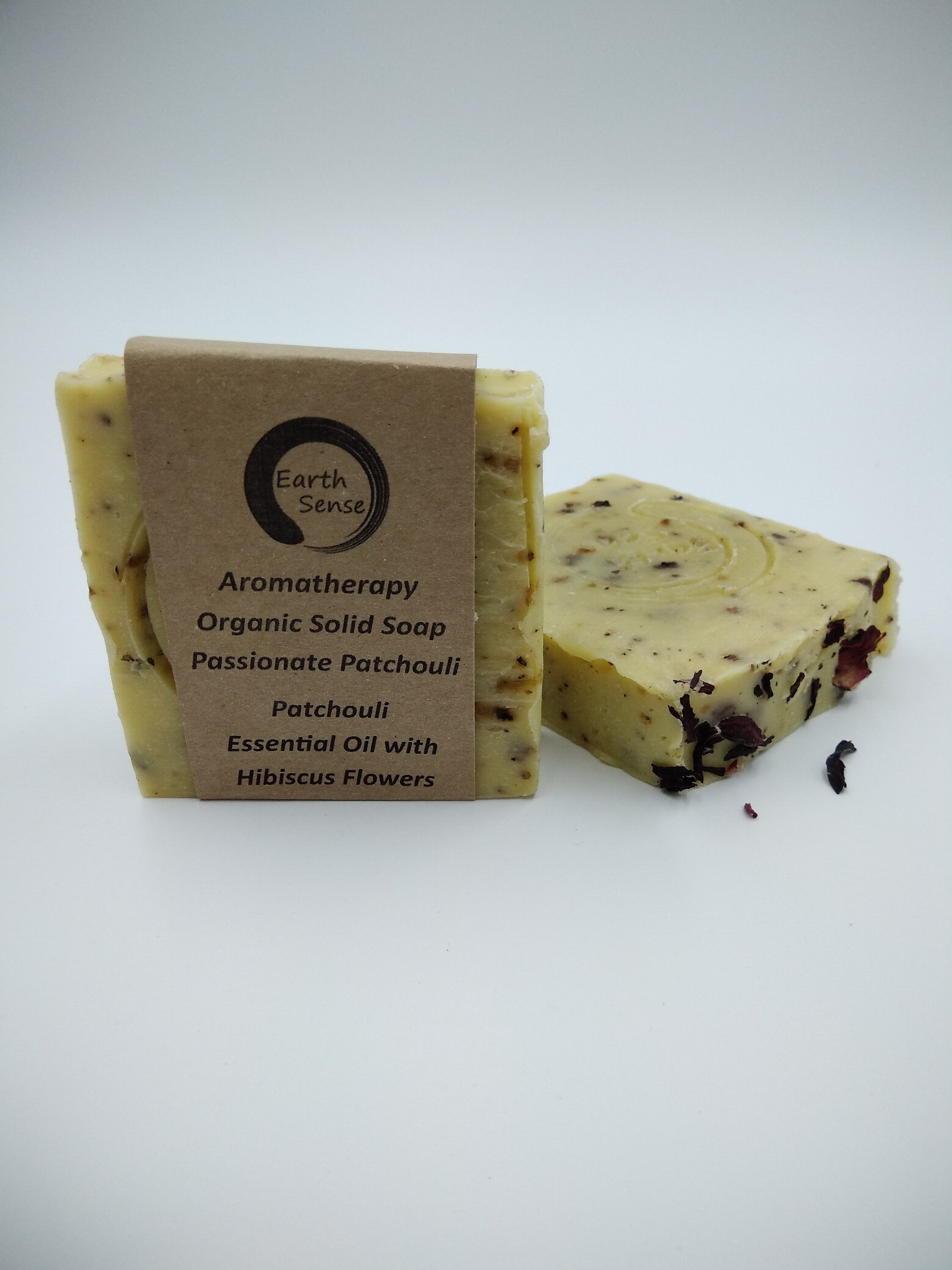 Organic Certified Solid Soap with Patchouli and Hibiscus Flowers, showcasing its natural ingredients and eco-friendly packaging.