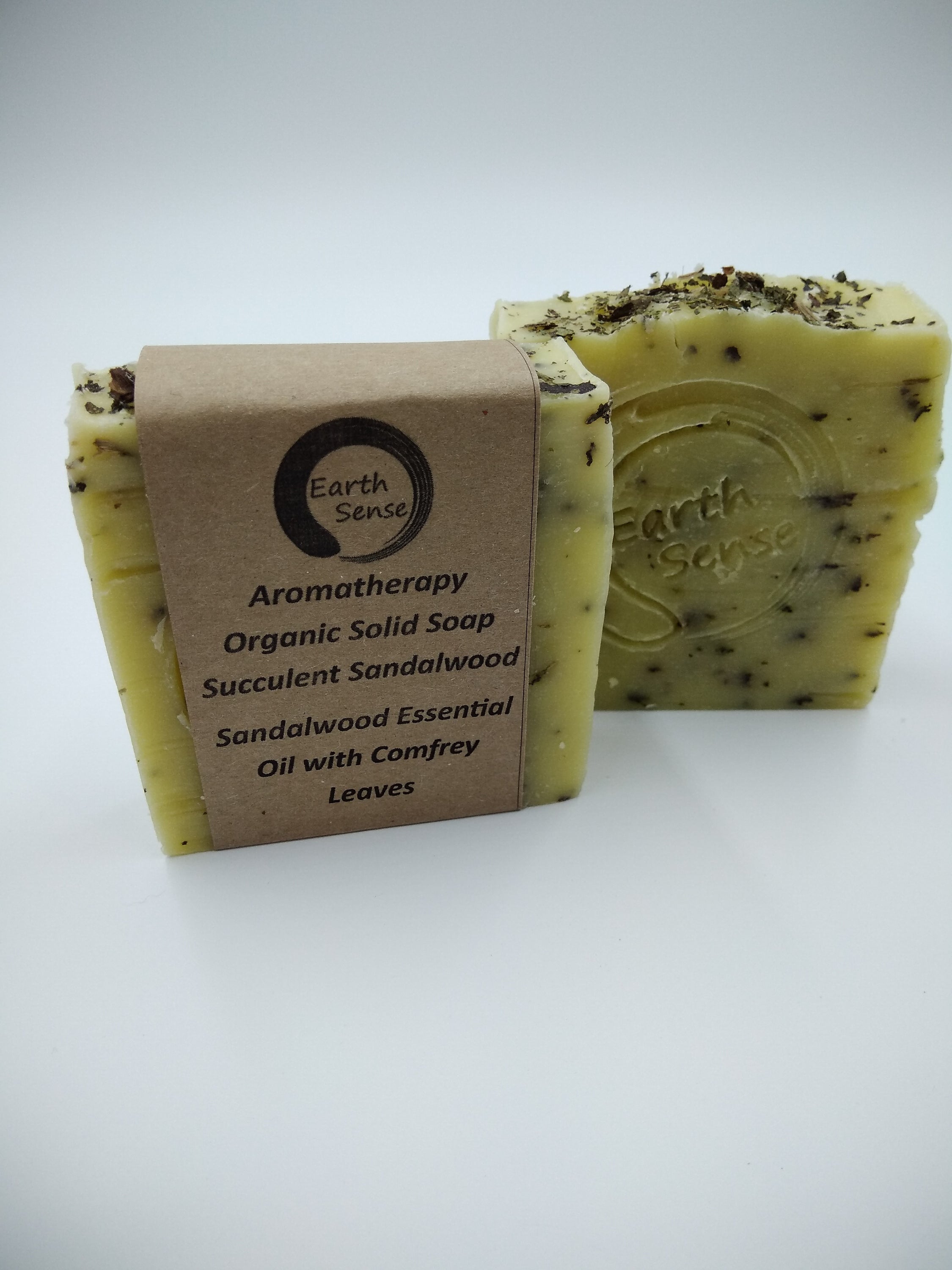 Organic Certified Solid Soap with Sandalwood and Shredded Comfrey Leaves, showcasing its natural ingredients and eco-friendly packaging.