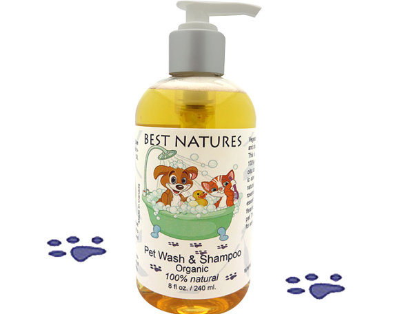 A bottle of Organic Pet Wash and Shampoo featuring a blend of natural oils, surrounded by fresh lemongrass and rosemary, showcasing its eco-friendly and vegan attributes.