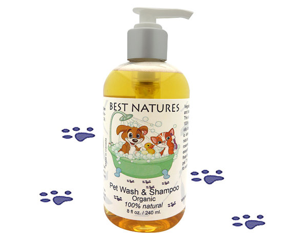 A bottle of Organic Pet Wash and Shampoo featuring a blend of natural oils, surrounded by fresh lemongrass and rosemary, showcasing its eco-friendly and vegan attributes.