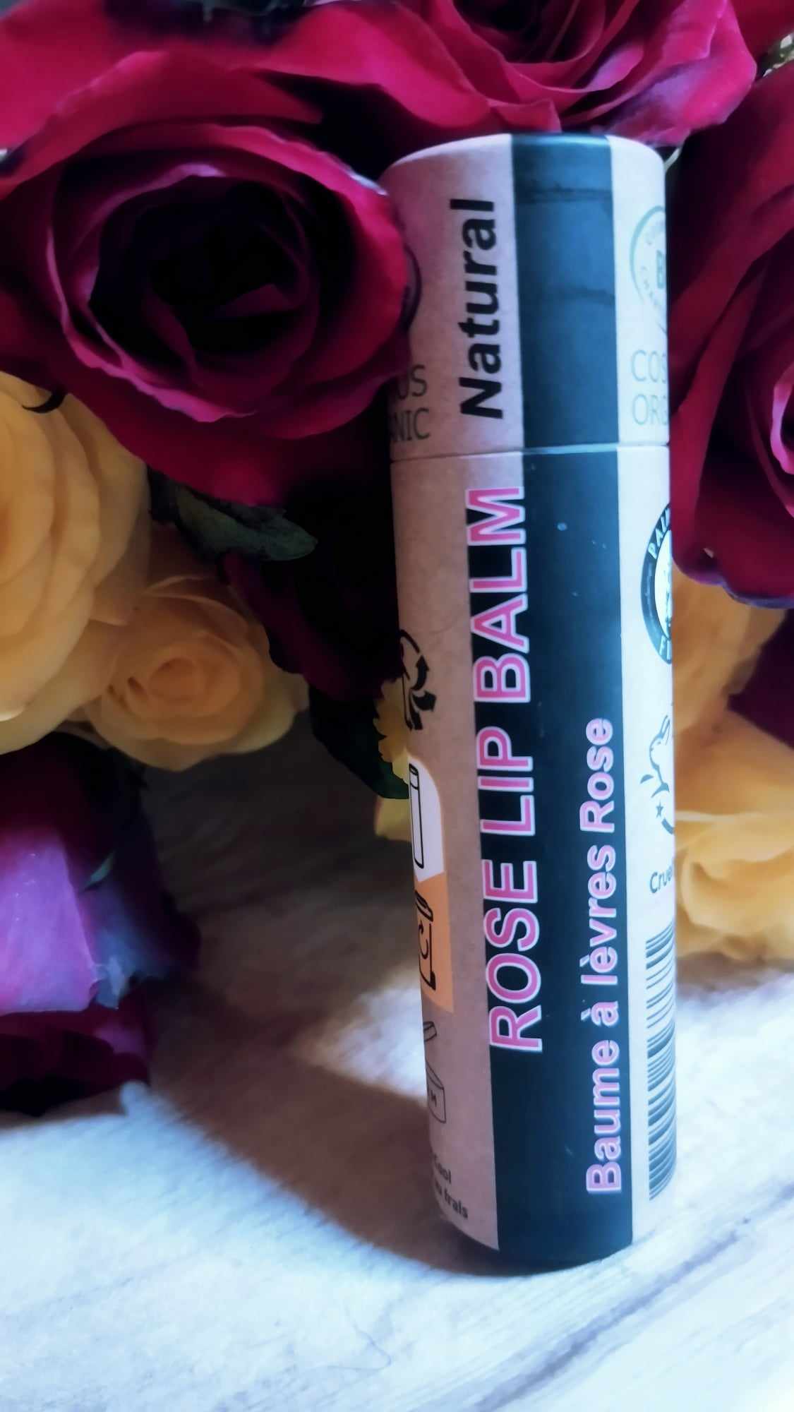 Organic Rose Lip Balm in a paper tube, showcasing its natural ingredients and eco-friendly packaging.