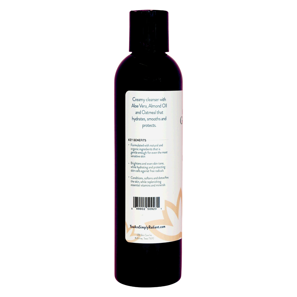 A bottle of Organic Skin Renewal Gentle Cleanser with a soothing label, designed for sensitive skin, placed on a marble countertop surrounded by natural elements.