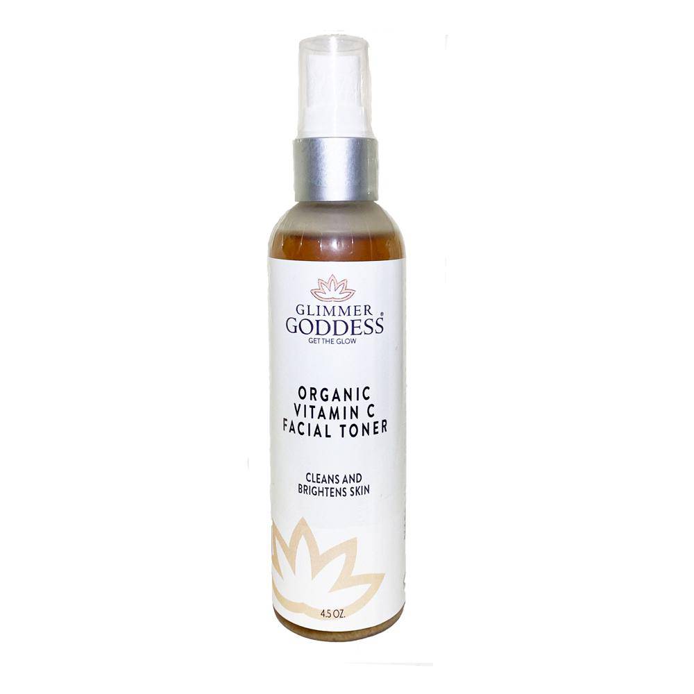 A bottle of Organic Vitamin C Facial Toner with a spritzer top, surrounded by fresh Kakadu Plum and aloe vera leaves.