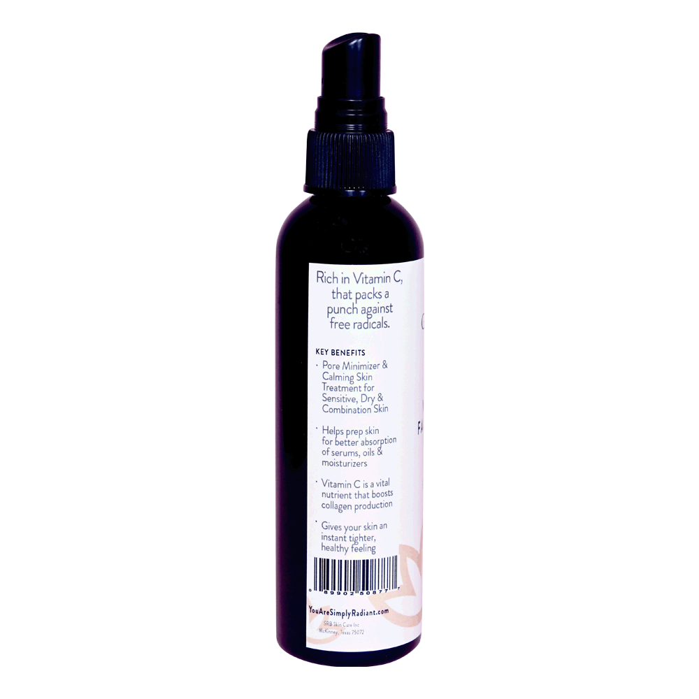 A bottle of Organic Vitamin C Facial Toner with a spritzer top, surrounded by fresh Kakadu Plum and aloe vera leaves.