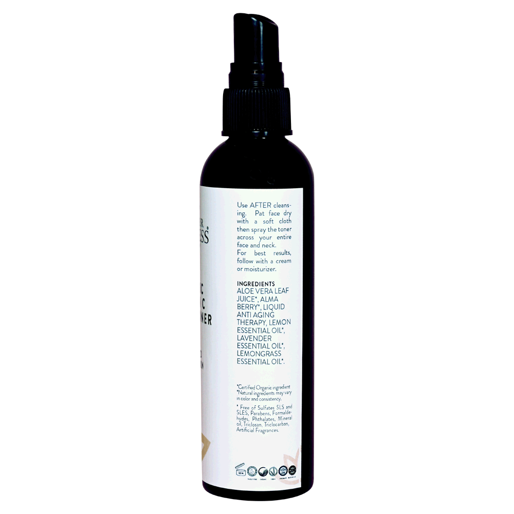 A bottle of Organic Vitamin C Facial Toner with a spritzer top, surrounded by fresh Kakadu Plum and aloe vera leaves.