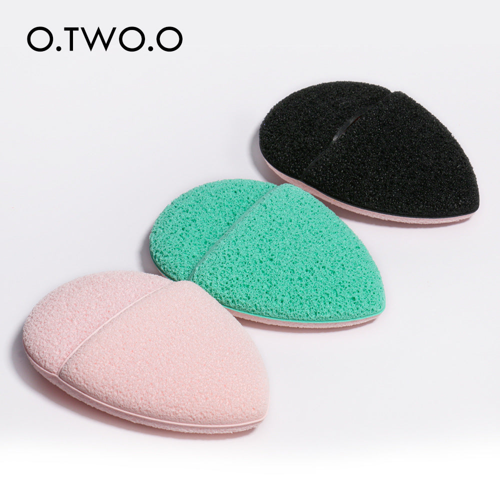 O.TWO.O Oval Soft Sponge Face Wash Puff in a vibrant color, showcasing its soft texture and ergonomic design for comfortable use.