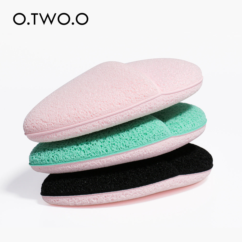 O.TWO.O Oval Soft Sponge Face Wash Puff in a vibrant color, showcasing its soft texture and ergonomic design for comfortable use.