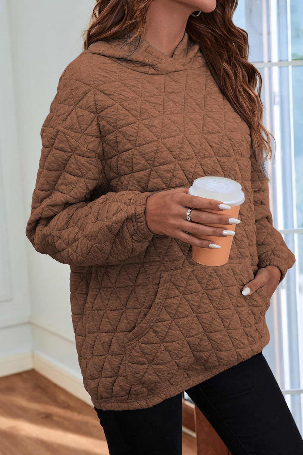 Pale khaki solid color quilted kangaroo pocket hoodie displayed on a mannequin, showcasing its stylish design and functional features.