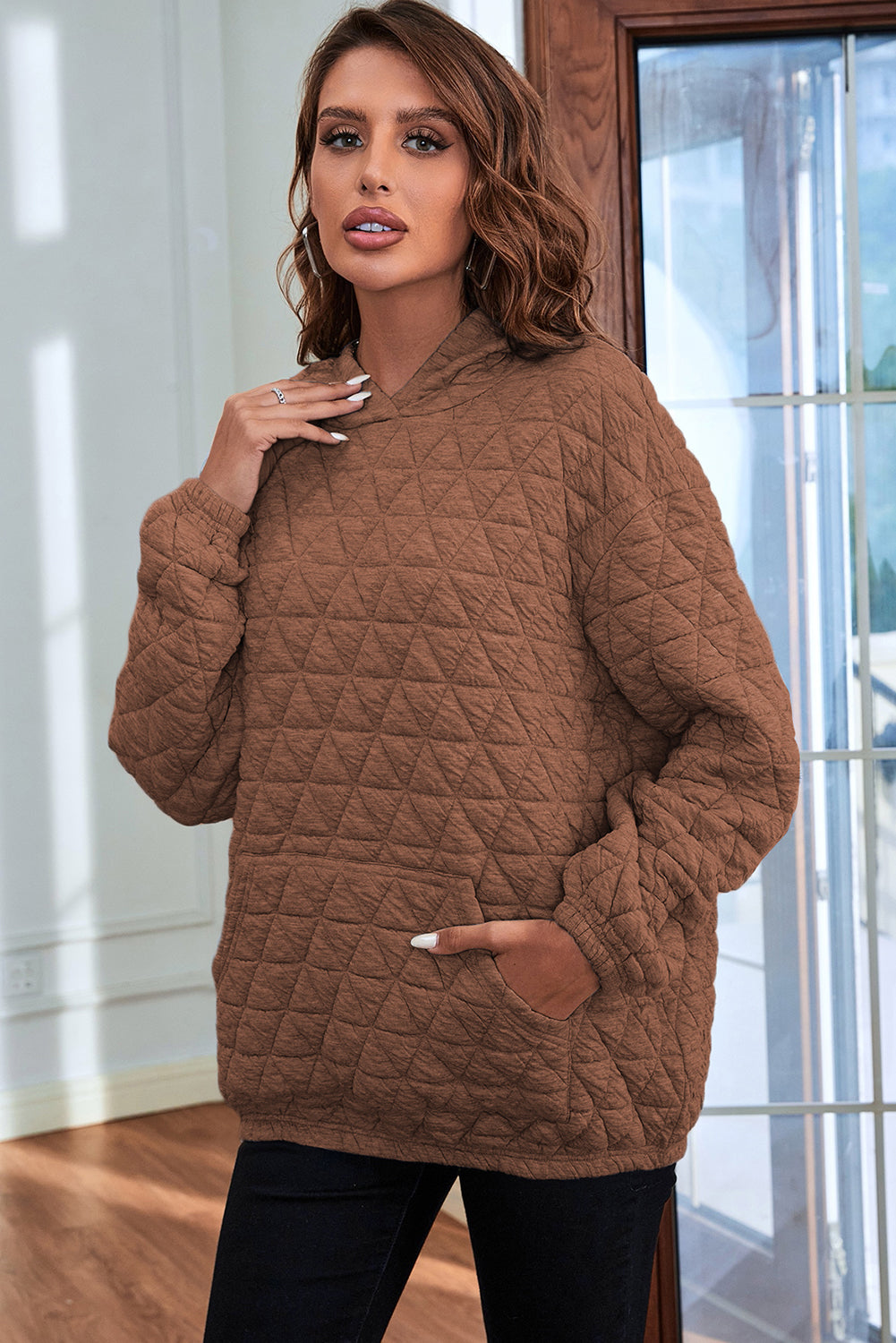 Pale khaki solid color quilted kangaroo pocket hoodie displayed on a mannequin, showcasing its stylish design and functional features.