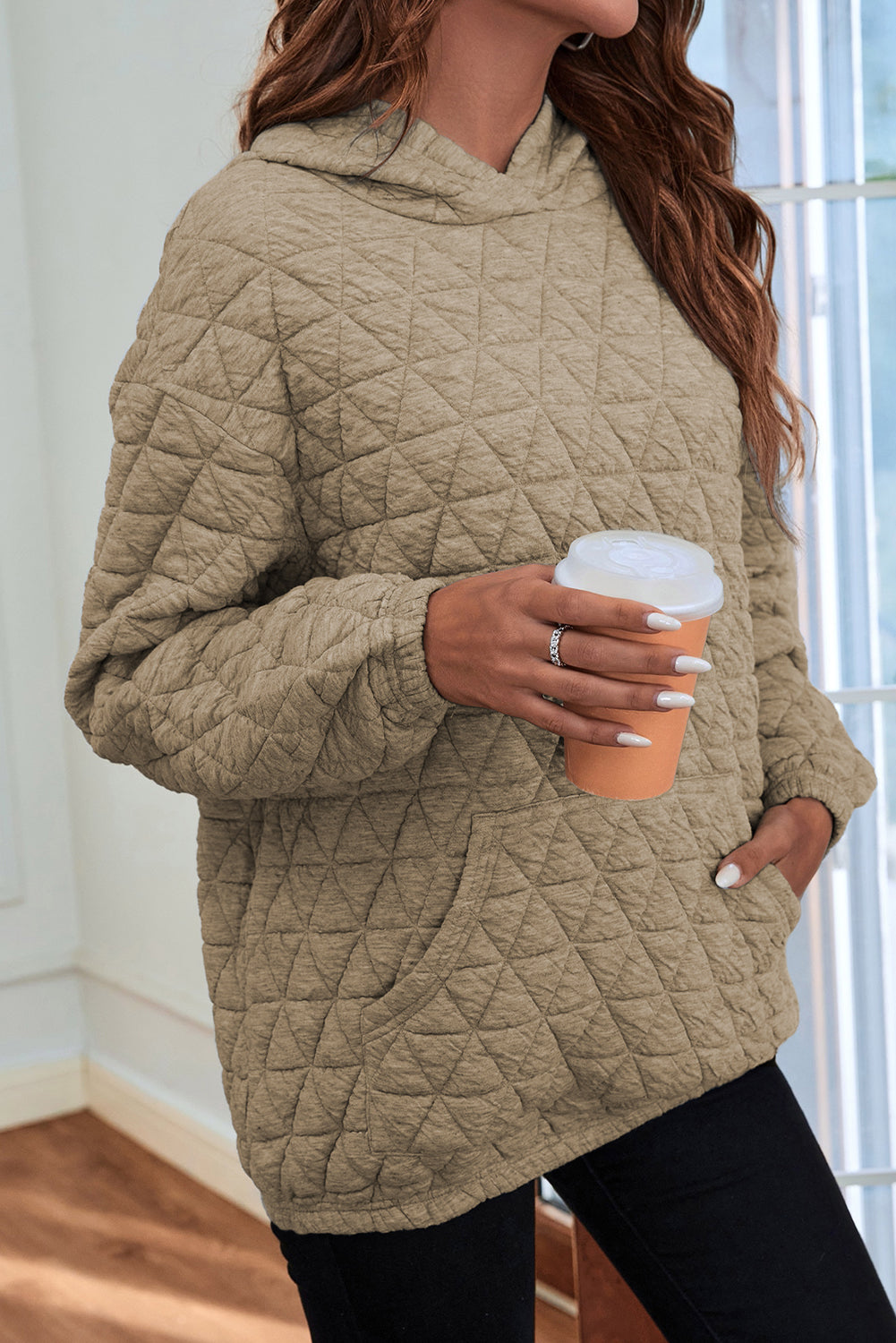 Pale khaki solid color quilted kangaroo pocket hoodie displayed on a mannequin, showcasing its stylish design and functional features.