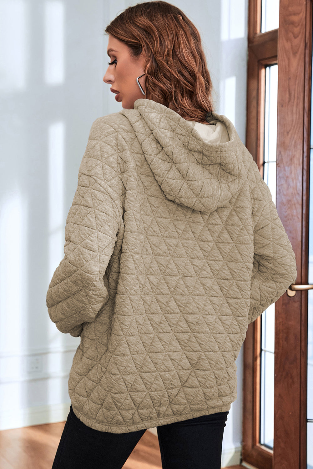 Pale khaki solid color quilted kangaroo pocket hoodie displayed on a mannequin, showcasing its stylish design and functional features.