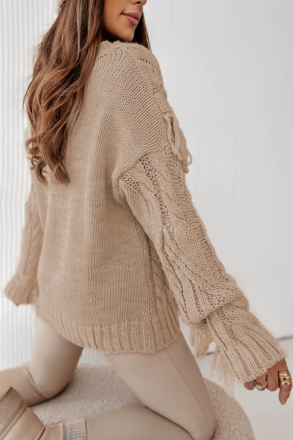 Parchment Tasseled Braided Knit Sweater featuring elegant tassels and braided knit design, perfect for winter fashion.