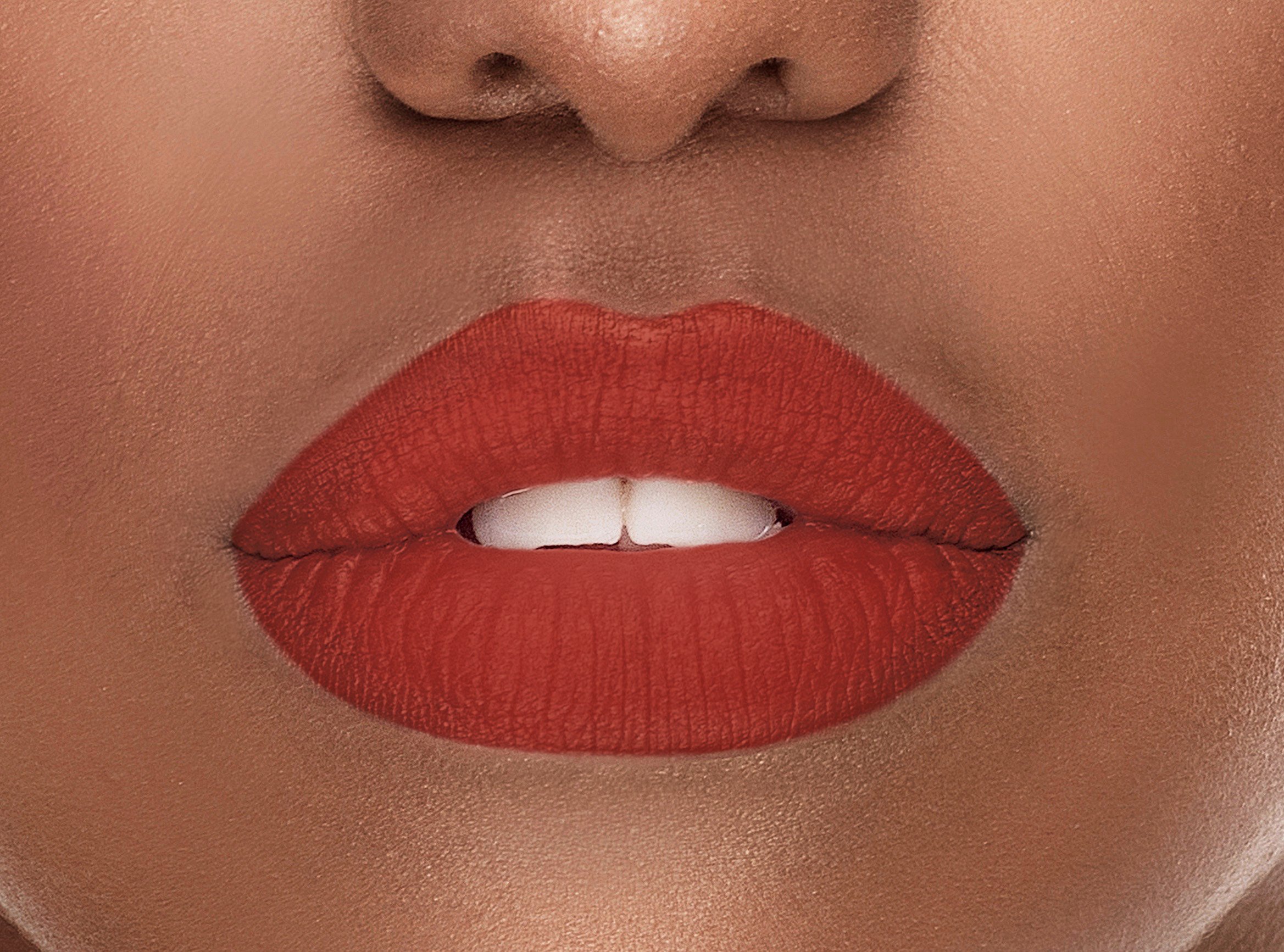 Passion Silk-Matte Lipstick in Deep Red Orange shade, showcasing its sleek design and vibrant color.