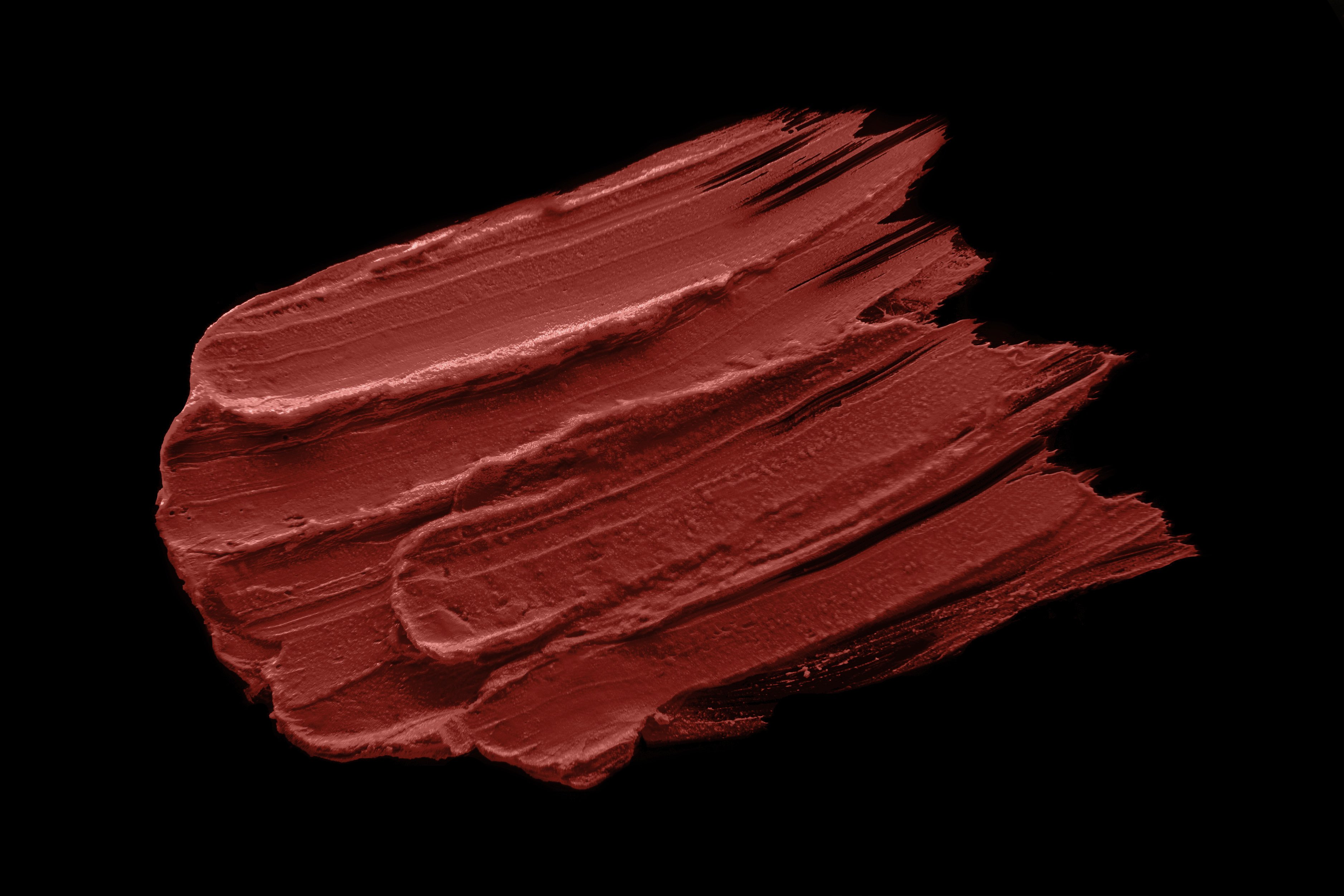 Passion Silk-Matte Lipstick in Deep Red Orange shade, showcasing its sleek design and vibrant color.