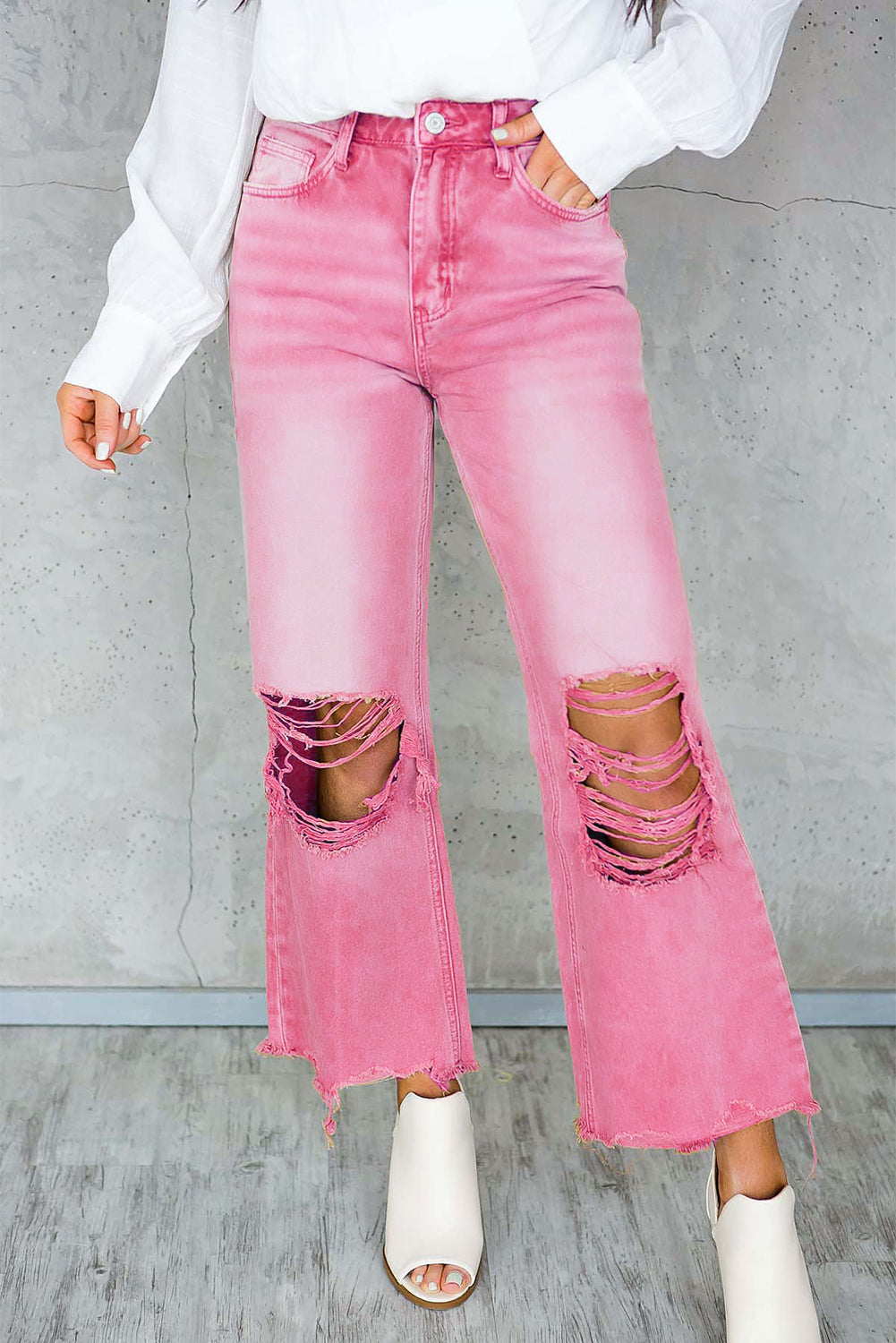 A pair of Peach Blossom Distressed Hollow-out High Waist Cropped Flare Jeans showcasing a vintage style with unique distressed details.