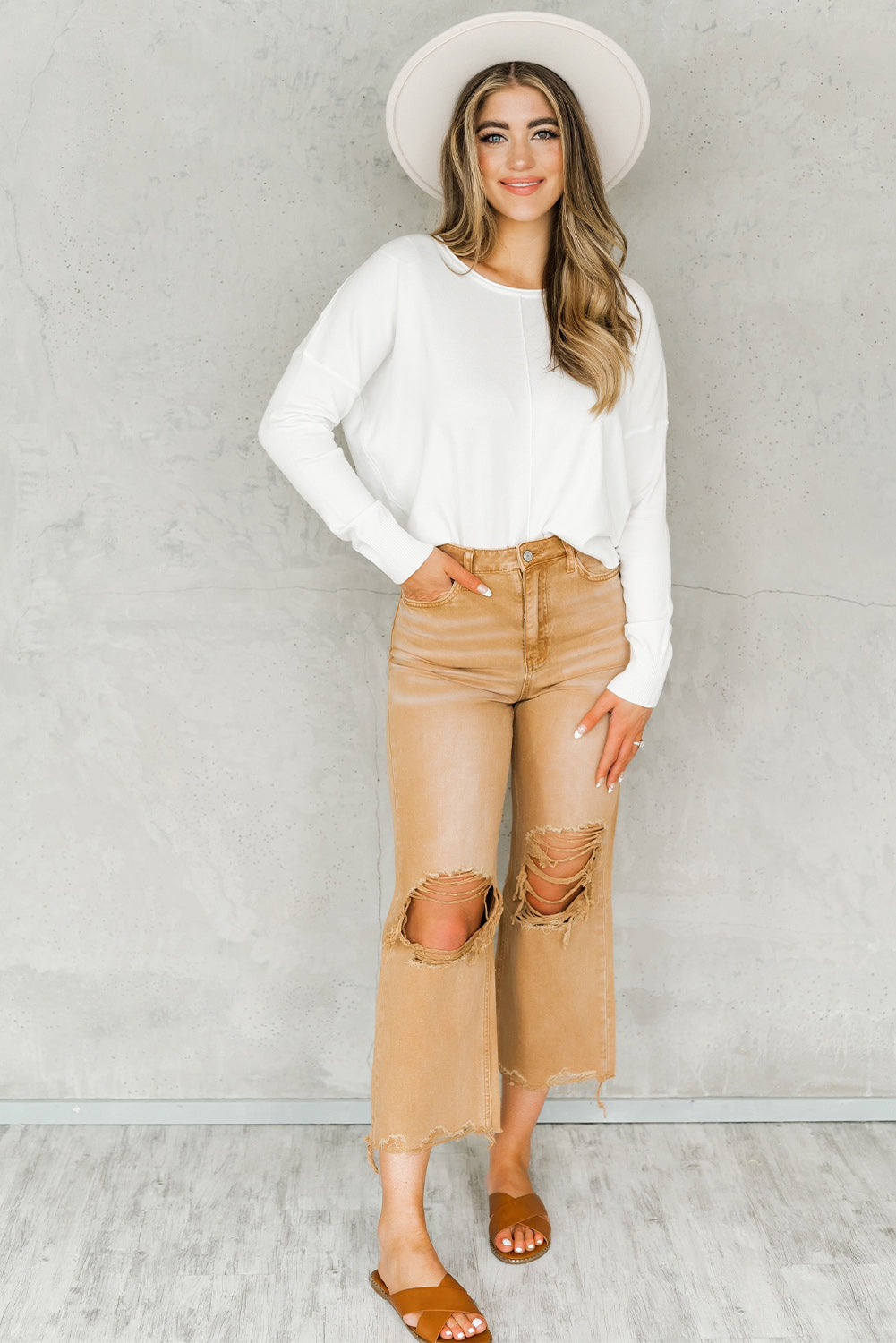 A pair of Peach Blossom Distressed Hollow-out High Waist Cropped Flare Jeans showcasing a vintage style with unique distressed details.