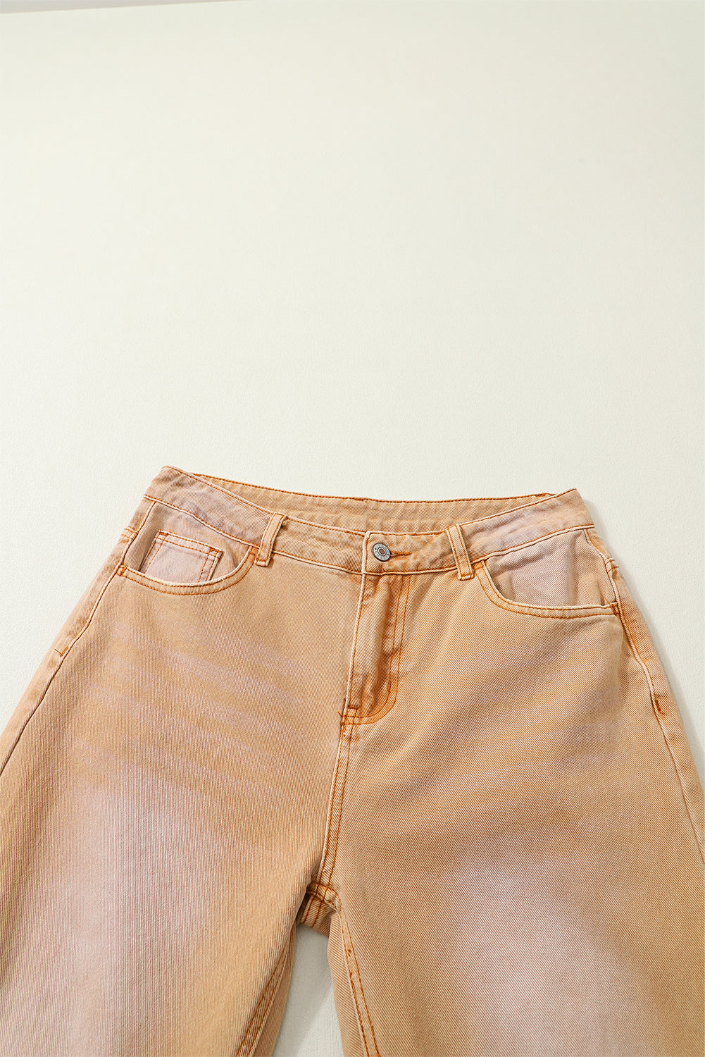 A pair of Peach Blossom Distressed Hollow-out High Waist Cropped Flare Jeans showcasing a vintage style with unique distressed details.