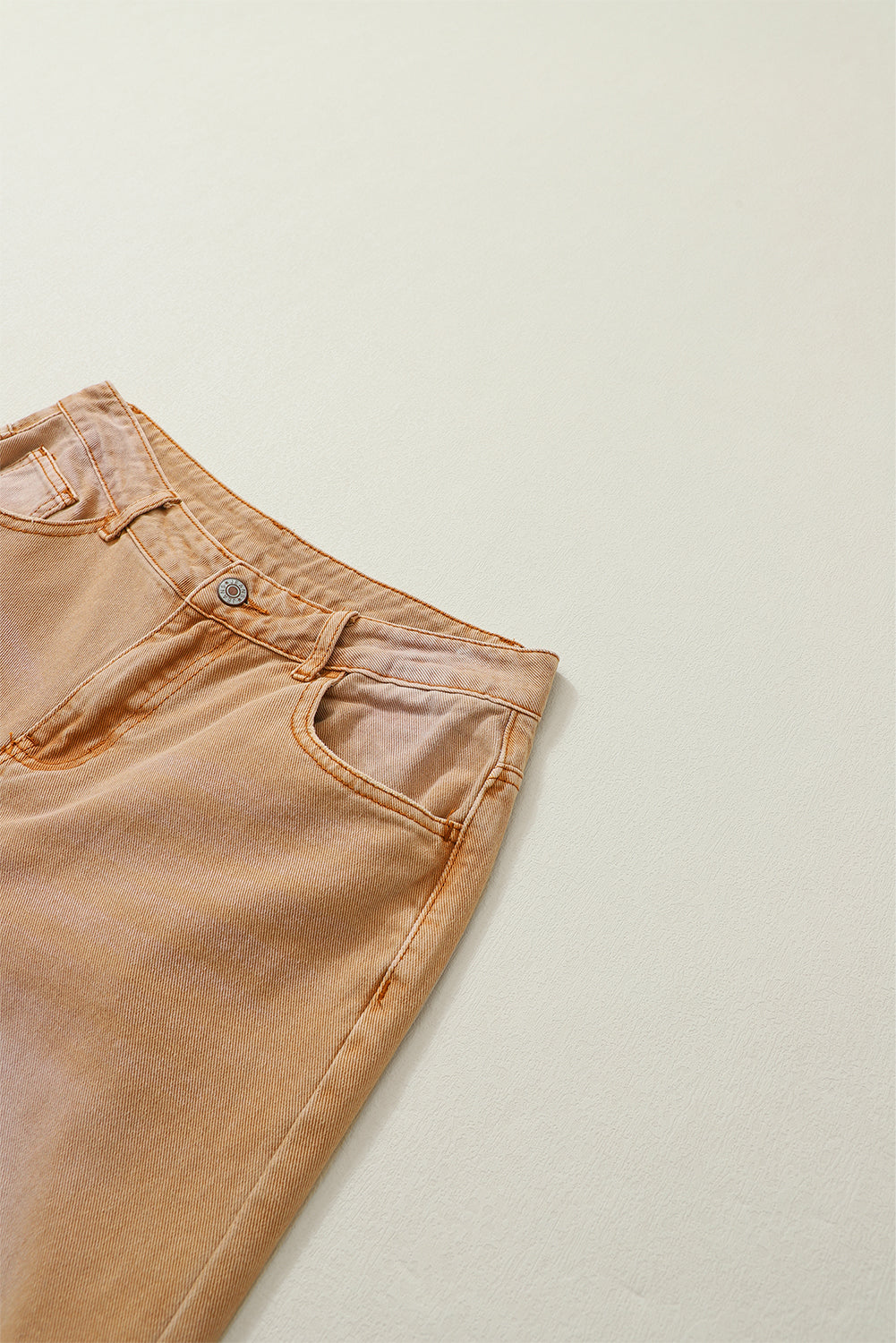 A pair of Peach Blossom Distressed Hollow-out High Waist Cropped Flare Jeans showcasing a vintage style with unique distressed details.