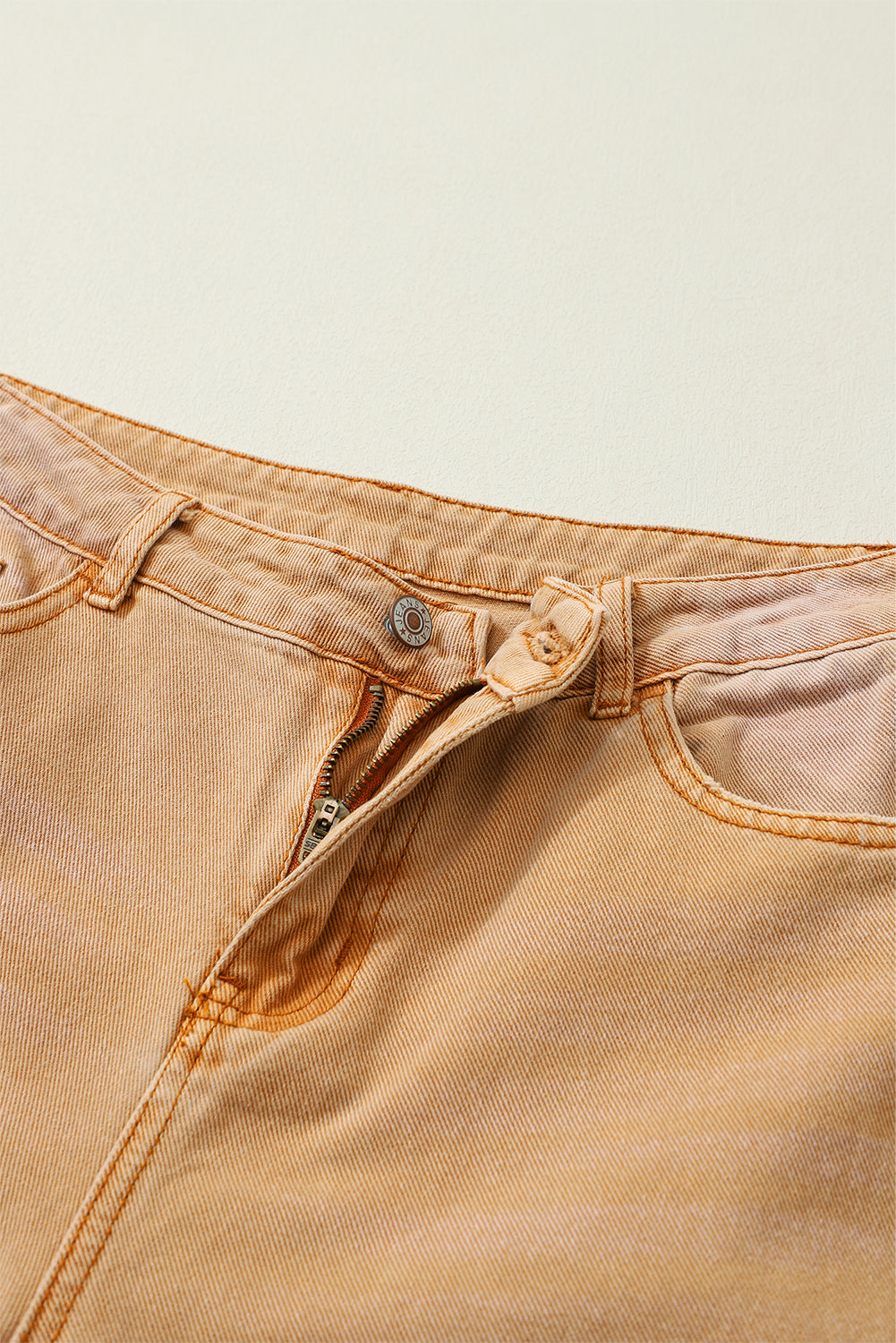 A pair of Peach Blossom Distressed Hollow-out High Waist Cropped Flare Jeans showcasing a vintage style with unique distressed details.