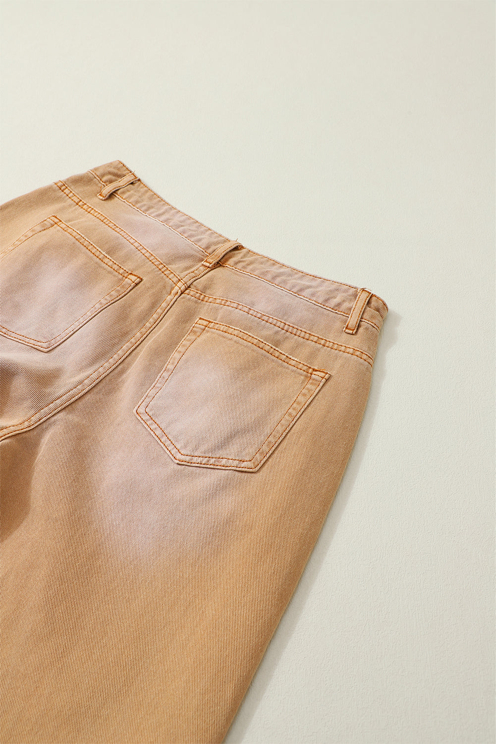 A pair of Peach Blossom Distressed Hollow-out High Waist Cropped Flare Jeans showcasing a vintage style with unique distressed details.