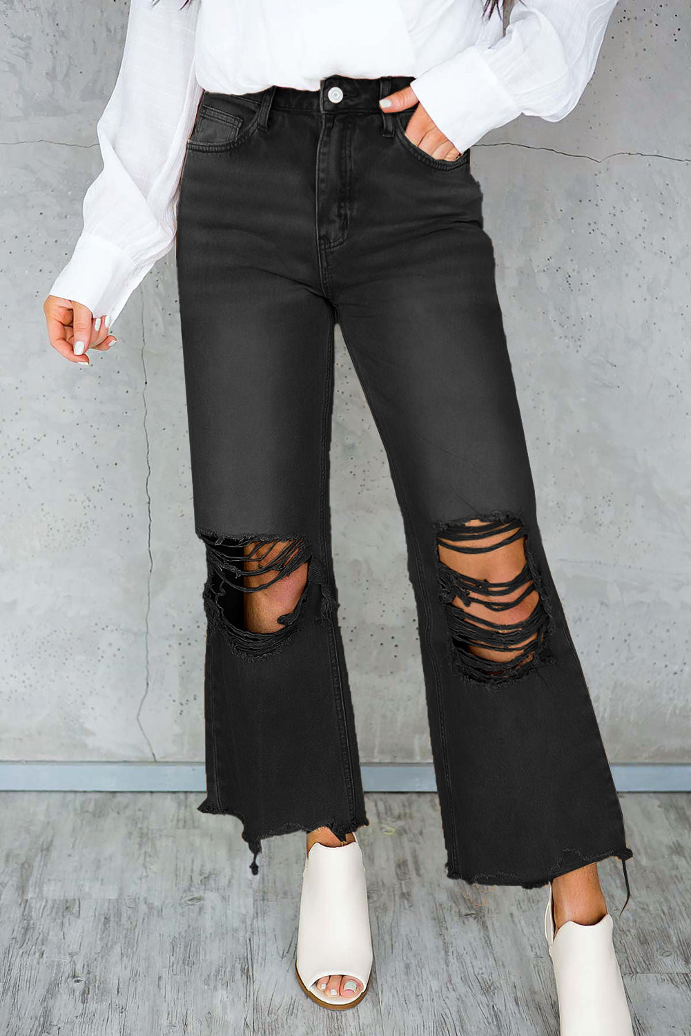 A pair of Peach Blossom Distressed Hollow-out High Waist Cropped Flare Jeans showcasing a vintage style with unique distressed details.